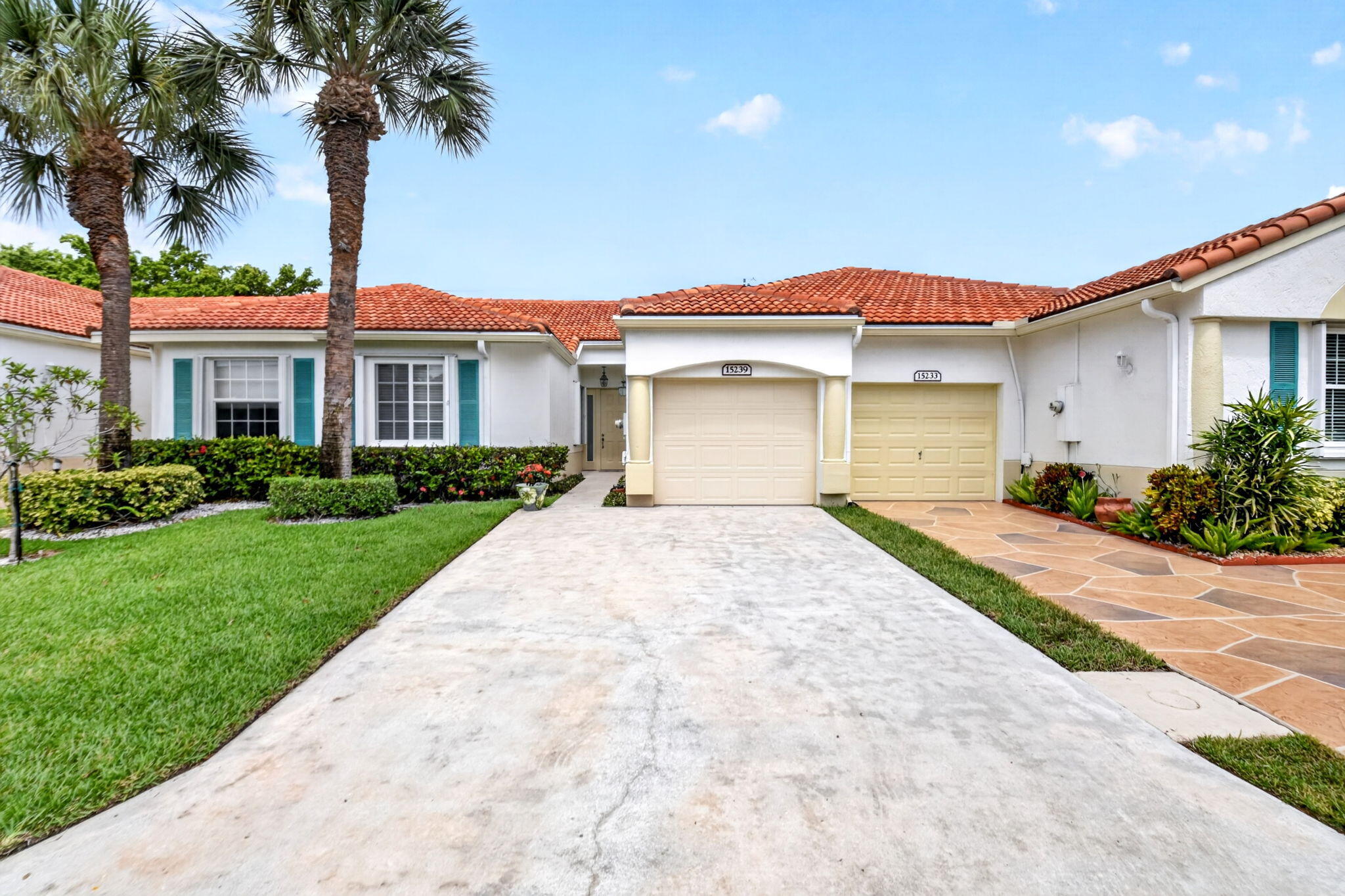 Beautifully updated 2-bedroom, 2-bath villa with a one-car garage in the desirable 55+ community of Floral Lakes. Located in the newer Phase 4 section of the community, this light-filled home features a renovated kitchen with solid wood cabinetry, 42-inch upper cabinets, stainless steel appliances, and a custom coffee and wine bar complete with a wine cooler. Both bathrooms have been completely remodeled, and all light fixtures and ceiling fans have been tastefully replaced throughout the home. Hardwood flooring enhances both bedrooms, while 18-inch tile flows throughout the main living areas.  The spacious primary suite offers a large walk-in closet, while the open living spaces provide a comfortable and inviting layout. Enjoy peaceful outdoor living from the tiled, hurricane-rated screen