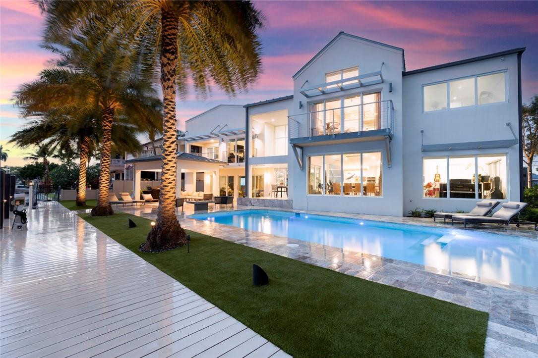 Breathtaking 5BR/4.5 Bath gated residence sited on 95 ft of WF with EXPANSIVE WIDE VIEWS of Rio Barcelona in the gated enclave of Sunrise Key. This home has been fully renovated w/new gym, larger primary closet and balcony were added, along with numerous outdoor upgrades including free standing gazebo, redesigned pool, backyard, new driveways, automated Gate and serious drainage system! Great home for entertaining with high performance chefs kitchen open to multiple spaces on the 1st level, Tremendous primary suite with soaring ceilings, awesome views and hidden adjacent WF office! Three Bedrooms plus the office face the water!  Walls of impact windows and doors throughout capturing the views and blending indoors with the expansive yard. Minutes to Las Olas, Beach and major highways