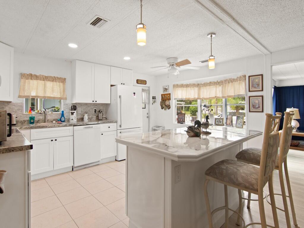 BEST VALUE IN SPANISH LAKES Tucked away on a quiet cul-de-sac, 8 Brisa Lane offers stylish updates and easy living in a welcoming 55+ community. This 2-bedroom, 2-bath home features a fully redesigned kitchen with soft-close cabinetry, updated counters, and new appliances. Both bathrooms showcase modern walk-in showers, contemporary vanities, and refreshed flooring throughout. A sun-filled Florida room adds extra living space and a bright, open feel. Residents enjoy a private golf course, two pools, pickleball, tennis, fitness center, shuffleboard, and more--all covered by the monthly fee. Schedule your showing today!