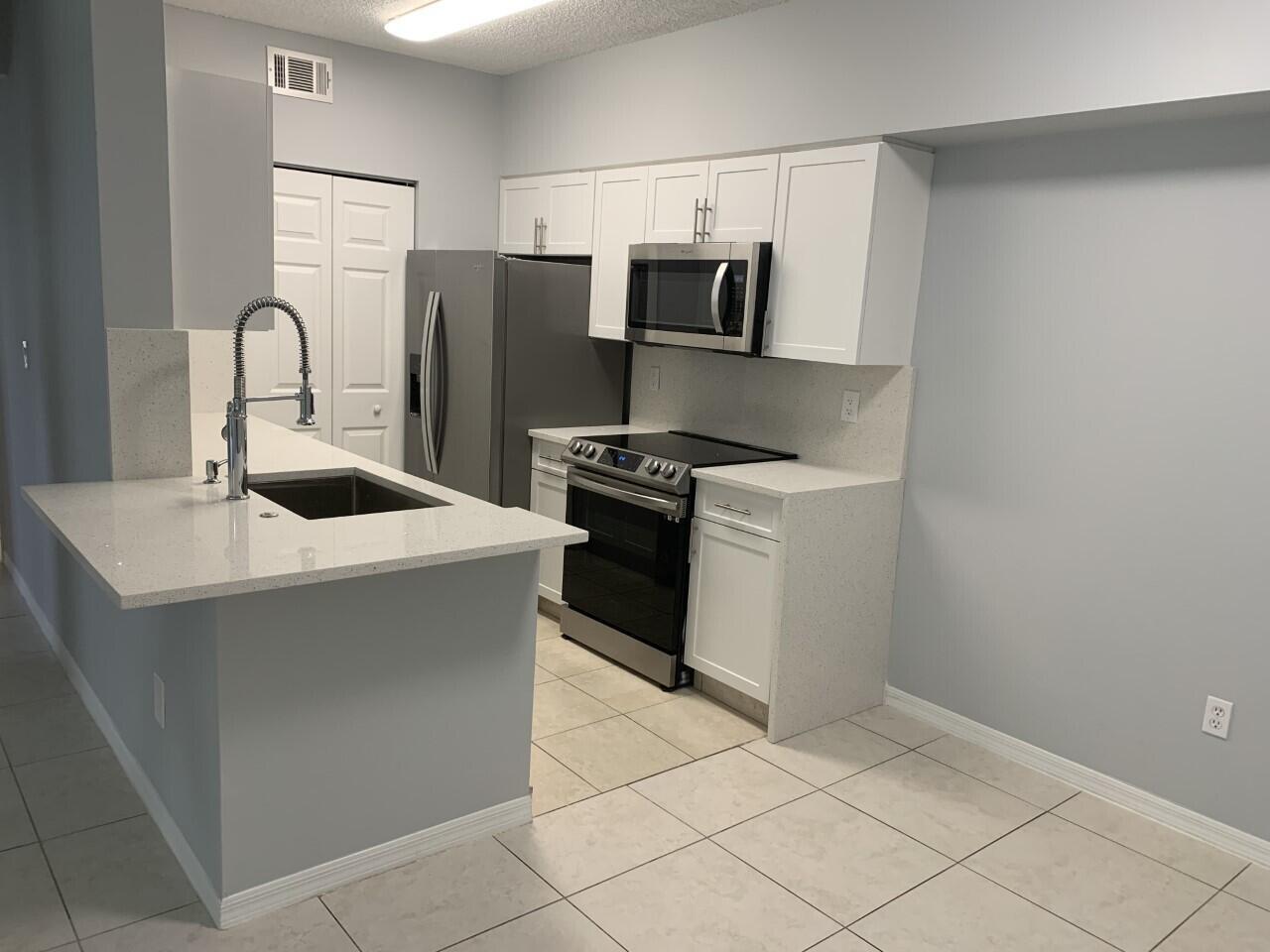 Welcome to this bright and stunning designed three-bedroom, two-bathroom condominium located in the Spa at Sunset Isles community in Royal Palm Beach, Florida. Updated Kitchen and Bathroom. The two-story design provides distinct living zones, allowing for efficient use of space and comfortable everyday living. This condominium presents an accessible entry point into the Spa at Sunset Isles community, offering residents the convenience of condominium living in Royal Palm Beach.