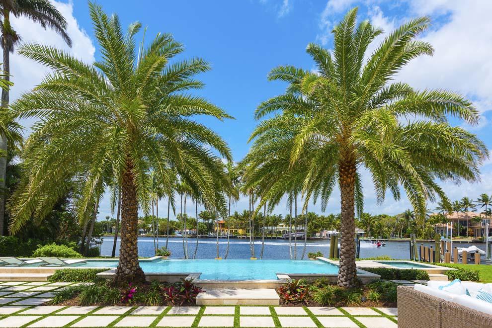 Boasting 161 feet of direct Intracoastal waterfrontage, 1010 Beach Drive invites South Florida luxury living. Nestled between two of East Delray's premier streets with a second entrance on 1031 Seaspray Avenue, the expansive waterfront compound is located blocks from the ocean and Atlantic Avenue's shops and restaurants. Recently renovated, the four-bedroom residence combines a coastal island flair with designer elegance to create a tropical oasis complete with stunning water views and an open floor plan that invites the outdoors in. The spacious covered loggia provides room for outdoor living and entertaining amidst the manicured grounds that perfectly frame the resort-style pool. Boating is a breeze with private dock, lift and nearby inlets. Enjoy serene seaside living at its best! Enjoy all that East Delray Beach has to offer plus easy access to Palm Beach and Boca Raton via A1A. Jetsetters will appreciate the nearby private airports and three international airports. Serious and recreational boaters alike will appreciate the 161 feet of direct Intracoastal waterfrontage with the added benefit of being set back on a basin providing wider unobstructed views with private dock, lift and a short distance to the nearby inlets.

Situated on almost two-thirds of an acre, the waterfront compound can be accessed via Beach Drive and Seaspray Avenue with an expansive pass-through driveway that provides ample parking. The manicured landscape accentuates the home's exterior with a walkway leading to the front porch. The impressive front door with glass feature provides a hint of the exceptional interior and water views that await.

Thanks to a major renovation, the interior enjoys an open floor plan with a coastal palette including hardwood floors, custom molding and high-end finishes throughout. The foyer flows effortlessly to the dining area, living room and covered loggia beyond. The living room has an entire wall of vanishing pocket sliders that invite the outdoors in with the covered loggia continuing to the tropical landscaped grounds, infinity pool and waterway beyond. The spacious chef's kitchen features top-of-the-line appliances including Subzero, Wolf and Thermador; large island with sink and snack bar seating; plenty of cabinets and storage; full-height wine cooler; pass-through door to dining room and a lovely breakfast area overlooking the waterway with a doorway to the covered loggia. 

The bedroom wing is conveniently situated at the north end of the home with each room located off of a generous hallway for maximum privacy. Two of the guest bedrooms have en suite baths and plenty of closet space. The generous master suite is complete with water views, white paneled ceiling, sliding door to pool and grounds, dressing area and completely renovated master bath with marble walls, custom glass walk-in steam shower, double sink vanity and inlay floors. The fourth bedroom could be converted to an office, play room or incorporated into the master suite as a closet. There is a full bath just off the living room and foyer. The laundry room is conveniently located between the kitchen and garage with separate entrances to the front driveway and the pool/outdoor shower. The laundry room has ample storage, a laundry sink and brand new full-sized washer and dryer. The two-car garage is bright with windows and a separate glass door to the backyard and plenty of room for work space and storage. There are three separate attics.

With 161 feet of direct waterfrontage set back from the main waterway, this property offers a rare opportunity for outdoor enjoyment on both land and sea. The covered loggia has plenty of room for outdoor living and dining with porcelain floors that extend out to the poolside terrace. Enjoy endless hours of outdoor entertaining and lounging around the resort-style infinity pool with sun shelf and spa. The tropical grounds include a sandy beach feature with built-in firepit all overlooking the waterway. The private dock has lift and water with electric that can be hooked up. Enjoy day trips along the Intracoastal or venture out on the high seas via nearby Boca Raton and Boynton Beach Inlets.

Major renovations completed in 2015/2016 include new paint in interior and exterior; addition of pool with Smart controls; hardwood floors installed; updated kitchen, laundry room with half bath, and master suite; covered loggia and outdoor living area with porcelain floor, awnings and cooking area with gas stub; custom cabinetry; impact windows with the exception of front door and dining area bay window; electrical updates including LED lighting; non-wood decking at dock; new zoned irrigation and landscape with raised grade/elevation throughout, gas firepit and pavers with synthetic turf spines at pool; new gutters and downspouts; new impact resistant garage door; and new paver walk ways.

The East Delray Beach compound provides privacy for tranquil retreats and plenty of room to entertain or take a golf cart ride to the nearby beach, shops and restaurants. The waterfront property located at 1010 Beach Drive is the perfect destination for enjoying South Florida Luxury Living.