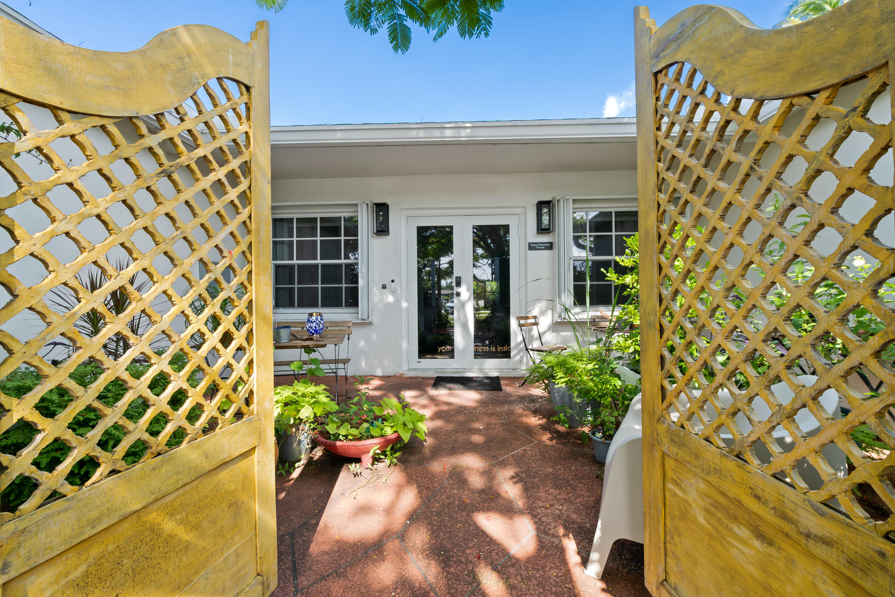 Welcome to this Exceptional "Well Kept" Tastefully renovated Over 2700sqft Bright & Airy 3/2 single family Split Floorplan offers an ideal combination of comfort, functionality, and distinctive architectural character with a lavish colorful Nature-Friendly design Butterfly Garden Oasis that creates a tranquil outdoor retreat with screened patio & private peaceful entry courtyard.  This beautifully renovated custom kitchen has been expanded to include a continuous wall of built-in cabinetry and additional workspace, creating a unique side by side layout with storage and preparation area rarely found in homes of this size. Stainless Steel appliances and stunning neutral colored Granite countertops opens seamlessly to an expanded Florida room featuring partial hurricane-impact windows and accordion shutters, enhancing both comfort and peace of mind. A unique sunken living room serves as an elegant transition between living spaces, connecting while subtly defining separate areas of the home. One wing features a private library retreat, perfect for reading, working, or quiet relaxation, while the adjoining family gathering area creates an inviting setting for entertaining guests and enjoying time with family. An intimate conversation space offers the perfect vantage point to appreciate the property's privacy, artistic character, and tranquil surroundings. Thoughtfully designed throughout, the home's layout creates a harmonious balance of openness and seclusion. Major updates provide peace of mind, including a NEW A/C system (2026), NEW electrical panel (2026) with EV charger readiness, Roof (2018), water heater (2016), and underground sewer pipe replacement (2020/2021). An additional split A/C unit in the back room adds comfort and efficiency. Spacious M/Bedroom with large upgraded doorless glass shower & walk-in closet. Guest bedrooms features walk-in closets with laminate flooring  & combo shower-tub with dual sinks . Conveniently located near the Florida Turnpike, shopping centers, restaurants, and entertainment. This enhanced and beautifully renovated residence is a rare niche property, offering outstanding value and the ideal Florida lifestyle. Don't miss this amazing opportunity - Properties like this Beauty don't come along often! Schedule your private showing today your won't regret !