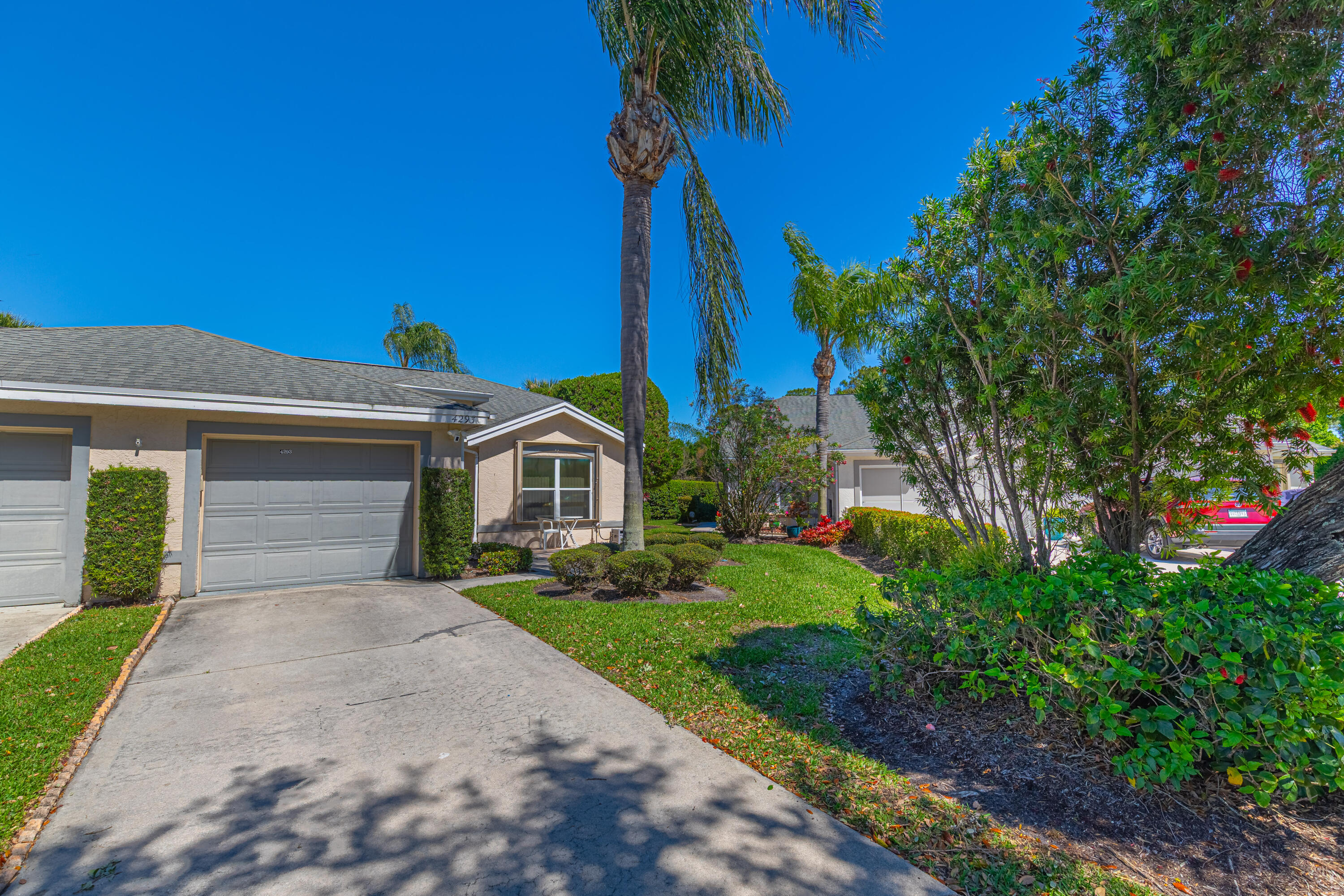 Nestled within the prestigious Garden of St. Lucie community, this exquisitely renovated 2-bedroom, 2-bath corner unit offers modern upgrades throughout. Step inside to discover soaring vaulted ceilings, Wood Floor throughout, freshly painted interior and exterior, elegant crown molding, and stylish new fixtures. The expansive open kitchen is designed for both functionality and entertaining, featuring stunning marble countertops, backsplash, custom wood cabinets, and high-end appliances. The spacious primary suite features a large walk-in closet and a fully renovated en-suite bathroom, complete with marble countertops and wood cabinetry. Additional updates include a new A/C and water heater (2024), Roof (2022), and roof over the lanai (2025). This home is further enhanced with new pavers, a welcoming front screen door, a Ring security system, and accordion shutters throughout. Enjoy the convenience of nearby shopping, parks, and the stunning Hutchinson Island beaches just 9 miles away!