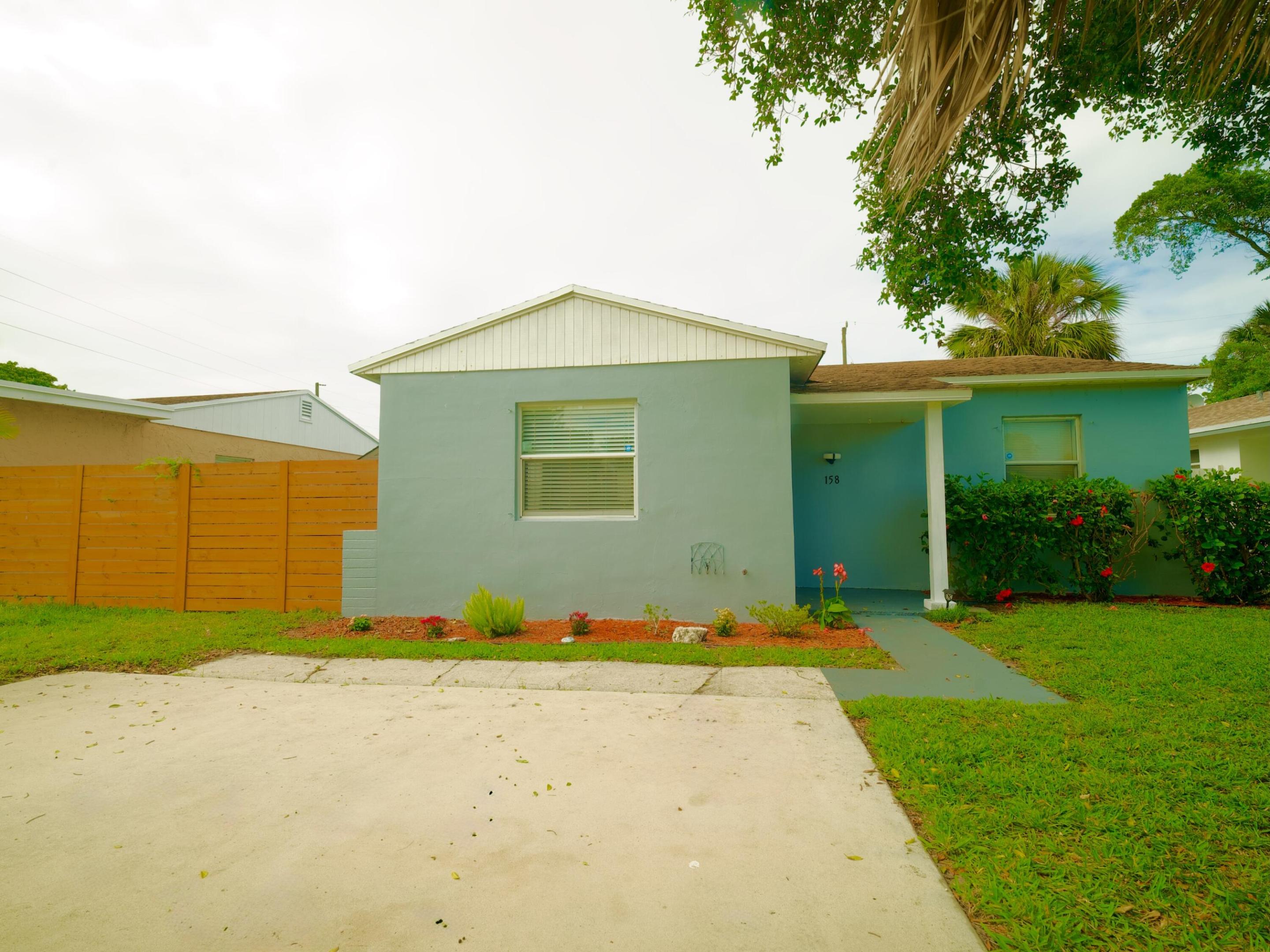 Charming opportunity steps from Singer Island! This property offers excellent potential for both homeowners and investors. Situated on a spacious lot, the home features a functional layout filled with natural light and plenty of room to customize to your personal style. Enjoy a fully fenced yard—ideal for entertaining, pets, or added privacy—along with a large shed for extra storage. Recently refreshed with interior and exterior paint, the property is move-in ready while still offering opportunities for value-add improvements. Major updates include a roof approximately 8 years old, along with a water heater and AC blower that are just 2 years old, providing added peace of mind. Conveniently located near shopping, di Conveniently located near shopping, dining, major roadways, and just minutes from the beach, this home delivers both lifestyle appeal and investment potential in a growing area of Palm Beach County. Don't miss your chance to own in a rapidly developing neighborhood with strong upside potential!