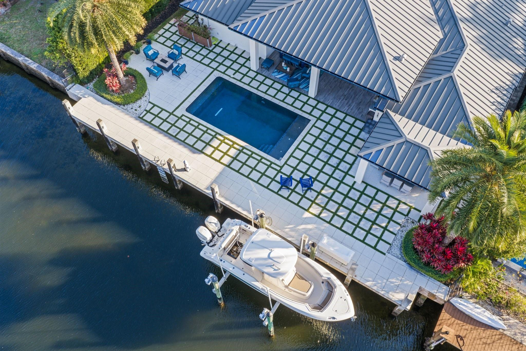 Premier,waterfront Coral Ridge Country Club home,expanded,fully remodeled and completed in 2018. 90' concrete dock,boat lift-15,000 lbs. Ocean access,no fixed bridges. Covered pergola with dining area,outdoor kitchen on covered patio. 5 bedrooms,3 full bath. Thermador appliances,gas range. Custom closets ,include a cedar lined one. Vaulted,wood ceilings in main area and patio,ship lap in the entry and family room, and coffered ceilings. 2 acs 2024/2025,impact glass/doors for the entire home,tankless hot water heater 2017,metal roof 2017,pool 2018. 2 car garage,epoxy floor,Garagetek,EV charger. 150-bottle wine cooler in bar. Walk to parks,restaurants,golf,beach-offering the Florida lifestyle at your doorstep. Bring your boat and move right in, with fishing, paddle boarding in your backyard.