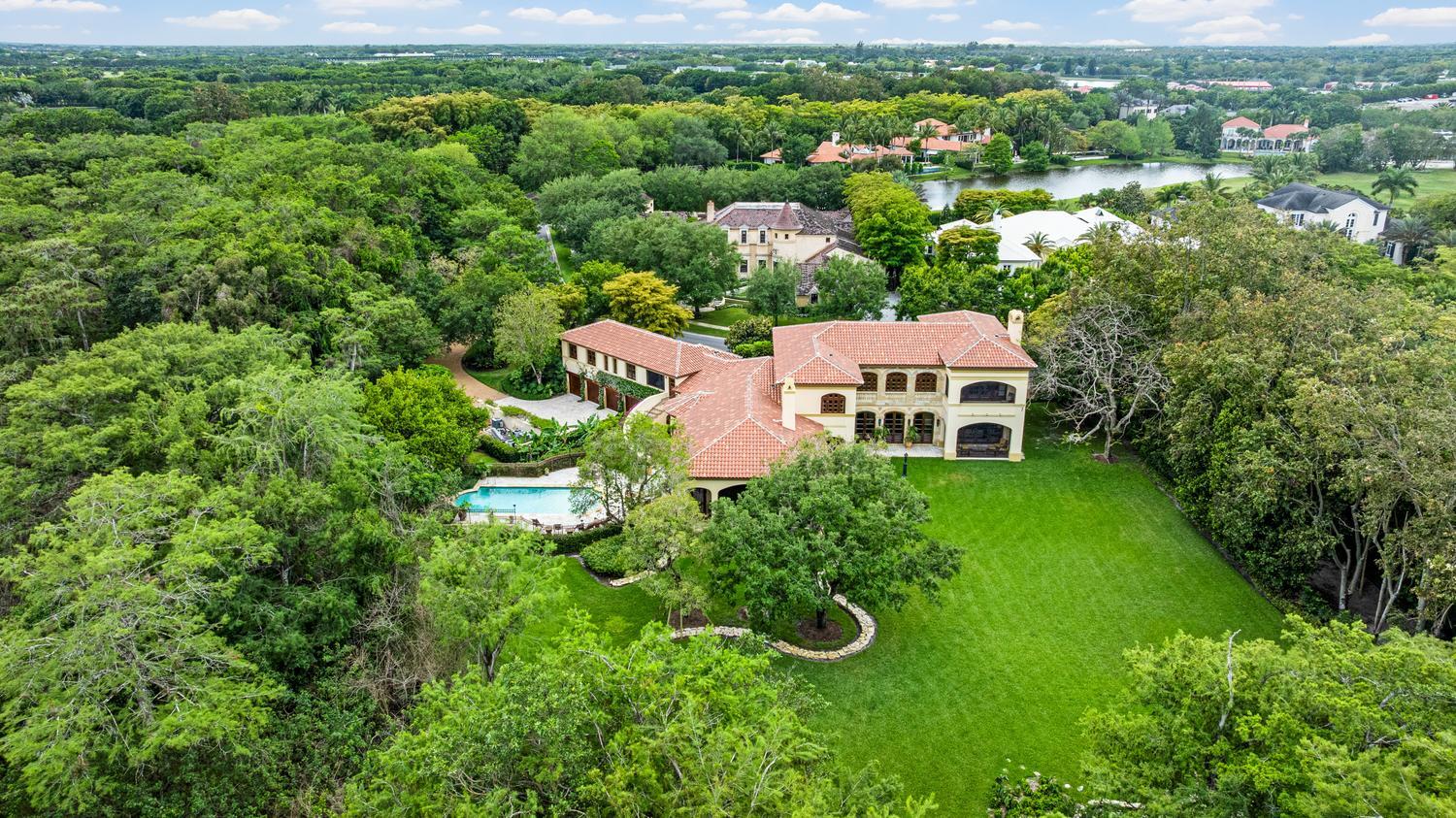 Spectacular estate on prestigious Hurlingham Drive, widely regarded as one of the most exclusive streets within Palm Beach Polo & Country Club. Set on an expansive 1.39 acre lot backing directly to a 92-acre tranquil preserve, this property offers exceptional privacy, sweeping green space, and serene, uninterrupted view — an increasingly rare combination in the community. The home is thoughtfully designed for both entertaining and everyday living, featuring a spacious kitchen with a butler's pantry, multiple living/family rooms, and seven well-appointed bedrooms. Two long, separate driveways provide a grand sense of arrival. The peaceful setting creates a true sense of retreat, all while being just moments from the renowned Wellington International showgrounds.