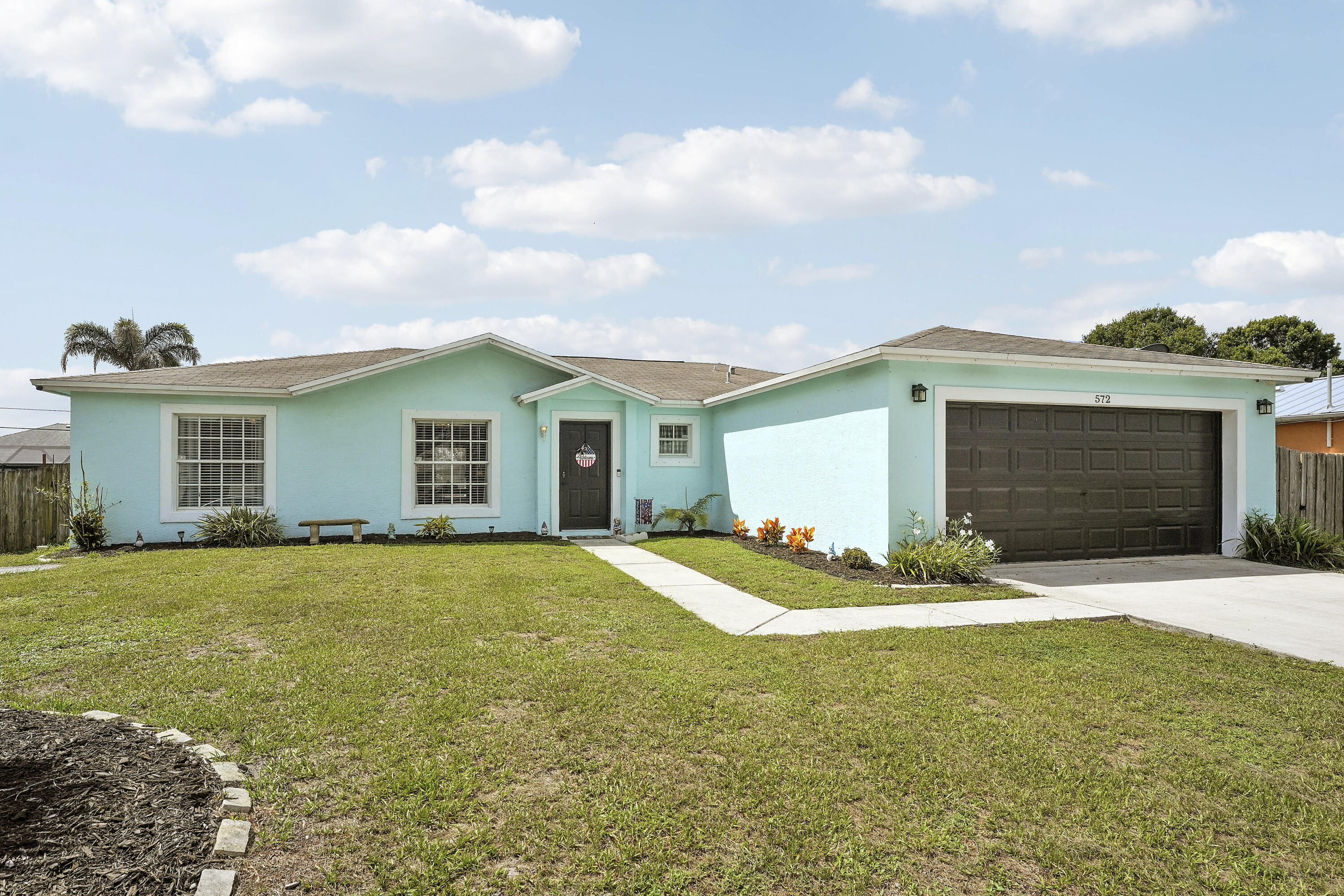 Welcome to 572 SW Bacon Terrace, a well-maintained 3-bedroom, 2-bath CBS home with 1,553 square feet of living space on an oversized 10,001-square-foot lot. Highlights include a brand-new 2026 roof, vaulted ceilings, durable flooring, spacious living and dining areas, and an updated kitchen with white shaker cabinets, stainless steel appliances, breakfast bar and pantry. The fully fenced backyard offers a gazebo, retractable awning, expansive lawn and room for a future pool. Additional features include an attached garage, extended driveway and space for boat or RV parking. Conveniently located near shopping, dining and major roadways. Schedule your private showing today!