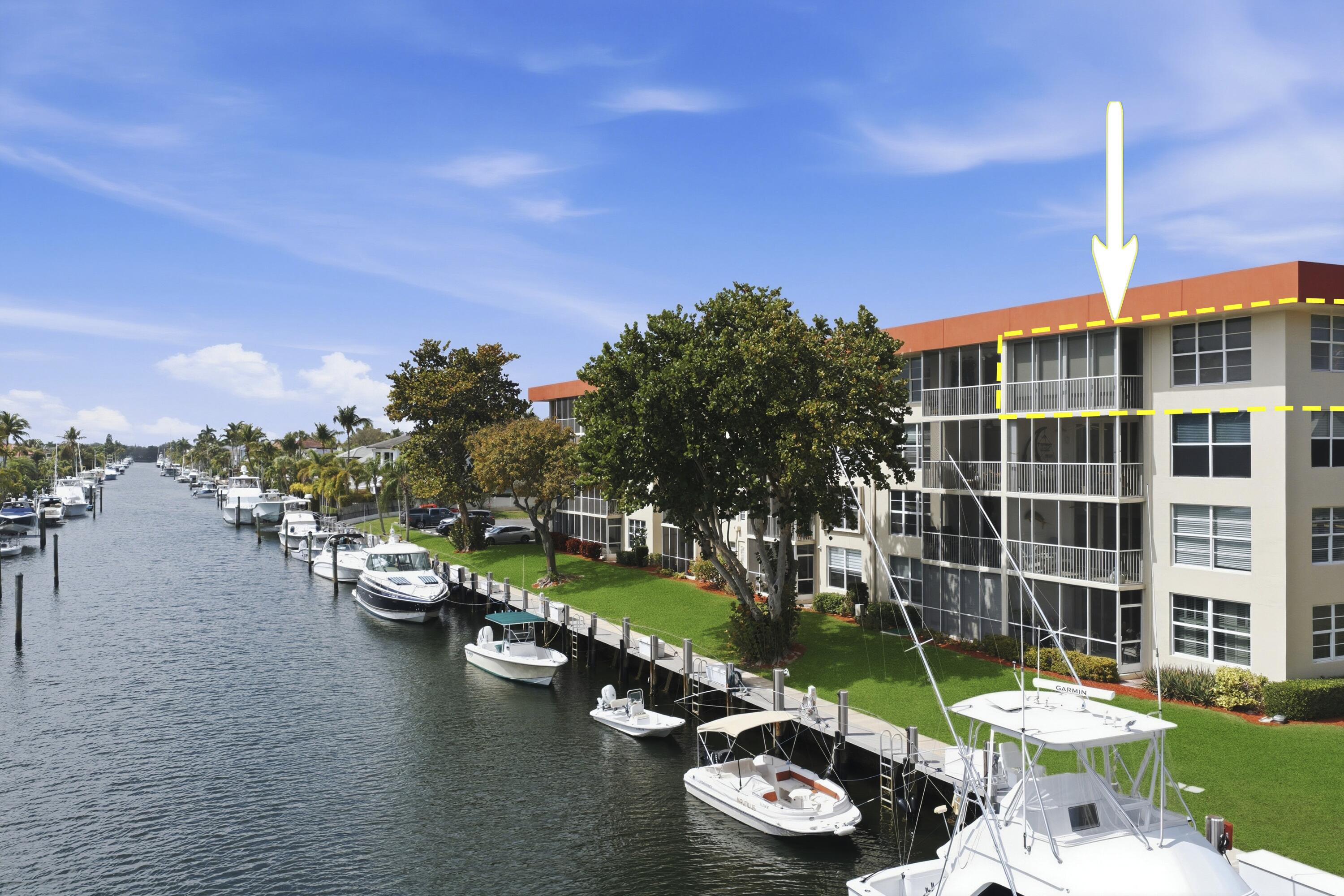 Enjoy coastal South Florida living in this updated 3-bedroom, 2-bath condo in the desirable Palm Aire at Coral Key community in Lighthouse Point. The bright, open layout features neutral tile flooring, spacious living and dining areas, and large sliding doors leading to a private screened balcony with direct water views—ideal for morning coffee or watching boats pass.  The kitchen includes granite countertops, stainless steel appliances, custom wood cabinetry, and a breakfast bar that opens to the main living space. Both bathrooms are renovated with modern tile, updated vanities, and a glass-enclosed tub/shower.  Dockage is available for lease, offering convenient boating access. Community amenities include a heated pool, clubhouse, BBQ areas, shuffleboard, and landscaped waterfront ground