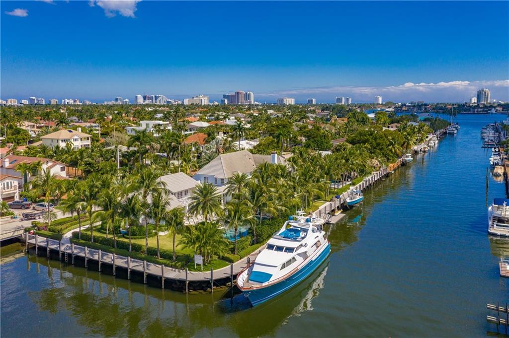 Welcome to your own slice of paradise in the prestigious Rio Vista neighborhood! This interior point lot boasts 300' of water frontage, perfect for the avid boater. Meticulous attention to detail throughout, features include Asta Italian kitchen w/ marble countertops, office, cabana bath, family room, 2 air conditioned workshops & "mancave." Equipped w/ Crestron Smart Home system, controls are at your fingertips. All impact doors & windows. Master suite w/ balcony to enjoy the water views, dual walk-in closets & updated bathroom. Enjoy a resort style backyard w/ infinity pool, custom landscaping & lighting, pergola & fire pit. Truly a special property & the perfect place to enjoy the outdoors all year long!