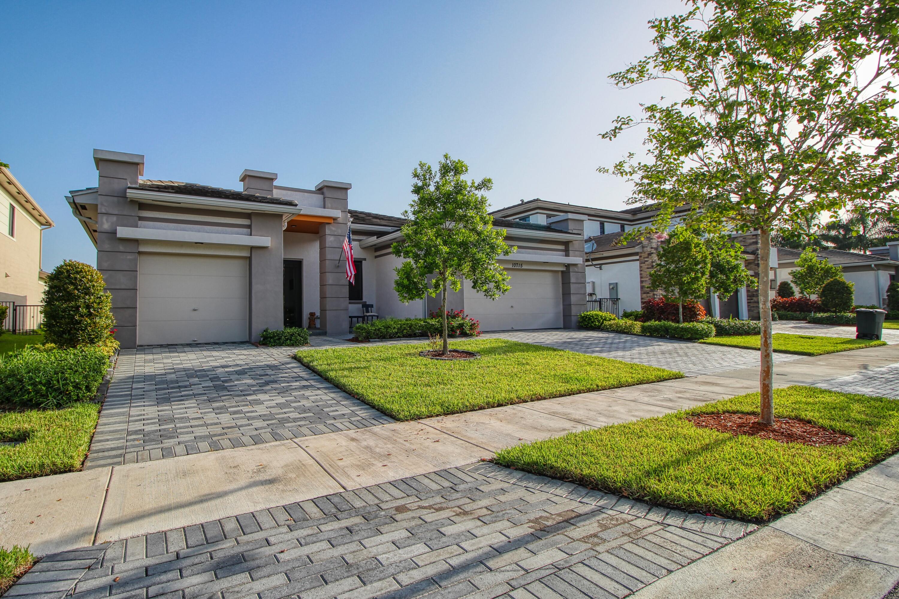 Contemporary waterfront home in the prestigious Presidential section of Cascata at MiraLago in Parkland. This bright, open floor plan is filled with natural light and offers beautiful lake views from many rooms. The gourmet kitchen features stainless steel appliances, white quartz countertops, and opens to the spacious living area. The primary suite overlooks the lake and includes dual vanities, a soaking tub, oversized walk-in shower, and custom closets. Enjoy a formal dining room, extended patio, huge fenced backyard, and a three-car garage with separate two- and one-car bays. Over $75,000 in upgrades include bamboo hardwood floors in all bedrooms, two Tesla wall chargers, epoxy garage floors, Restoration Hardware fixtures and a motorized sunshade.