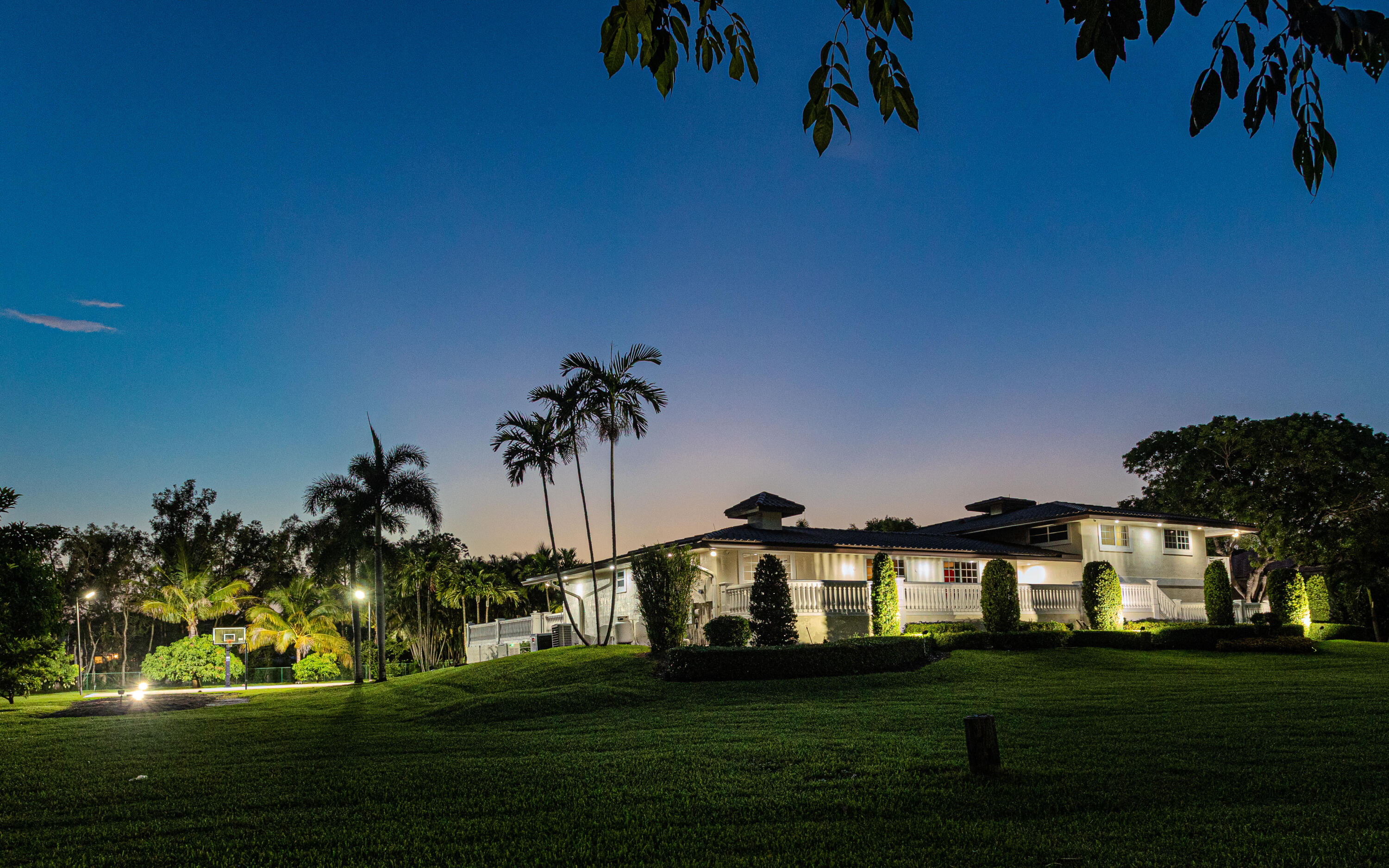 Situated in sought-after Horse Country in Plantation Acres, this 1.39-acre gated estate offers privacy, space, and exceptional flexibility with no HOA. The multi-level residence features 5 bedrooms, 4 bathrooms, home theater, exercise room, and basement, ideal for entertaining, multigenerational living, or a custom redesign. Outdoor highlights include a heated second-level saltwater pool, expansive deck, wraparound balconies, half basketball court, generous lawn areas, and lush tropical landscaping. With its oversized lot, this property offers a rare opportunity for a private compound, luxury renovation, or future vision in one of Plantation Acres' most desirable locations near Sawgrass, major highways, FLL, and beaches. Set on 1.39 acres in the highly desirable Horse Country area of Plantation Acres, this private estate offers exceptional space, flexibility, and lifestyle appeal. The unique multi-level layout is ideal for entertaining, multigenerational living, or a luxury redesign, with a basement, theater, exercise room, and multiple flexible living spaces. Outdoors, enjoy a heated second-level saltwater pool, wraparound balconies, half basketball court, expansive lawn areas, and lush tropical surroundings. The generous lot size also provides long-term flexibility for buyers seeking a private compound, estate enhancements, or future vision.