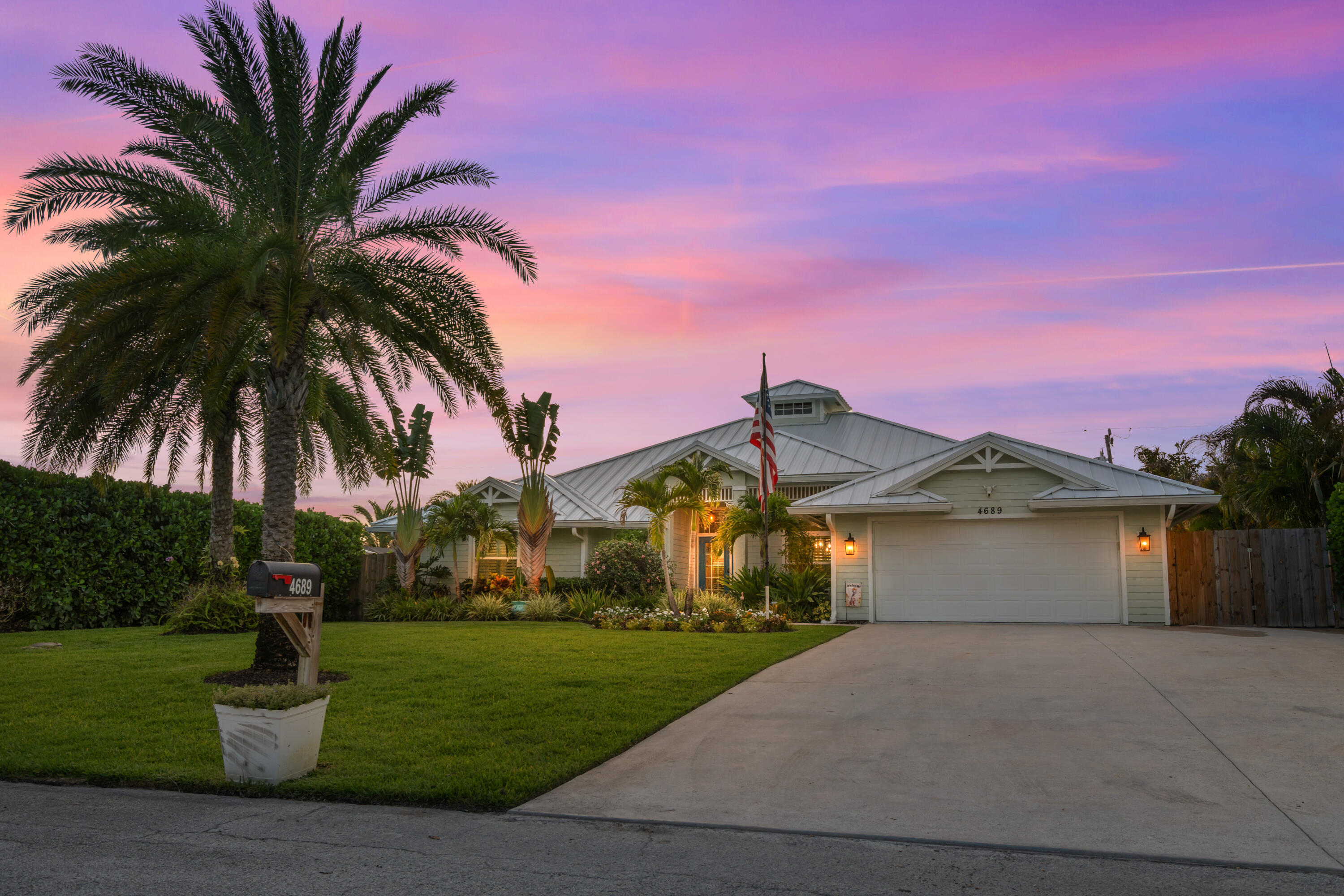 This renovated residence offers an impressive configuration of four bedrooms and two and a half bathrooms, complemented by a two-car garage. The home showcases a wealth of modern upgrades and enhancements that elevate its appeal. The property features a newly installed white seamless roof, completed in 2024, ensuring both durability and aesthetic integrity. A new fence was installed in 2026, accompanied by a substantial investment in landscaping enhancements between 2021 and 20 26. Notable elements include artificial grass and a dedicated chipping and putting green, finalized in 2026, as well as over 25 low-voltage lights adorning every palm tree. The residence is equipped with impact windows and doors, installed in 2023, providing superior protection. Additionally, the garage door is hurricane-rated, having been upgraded in 2022. The outdoor kitchen is designed for functionality and enjoyment, featuring a flat grill, insert grill, wine cooler, and two additional drink coolers. The area is enhanced by granite countertops and includes a separate sub-panel plumbed for gas, with a quick connect feature for a pizza oven. The pool underwent resurfacing in 2021, featuring elegant travertine decking. A new variable speed pool pump and heater, equipped with a wireless Pentair system and adjustable fluorescent lighting, are scheduled for installation in 2024. The interior has new flooring, installed in 2024, alongside full-core doors replaced in 2023 and updated kitchen countertops and cabinets from 2021. The presence of a gas stove and an owned 250-gallon propane tank enhance the kitchen's utility. The bathrooms received updates in 2021, featuring Serena Lilly wallpaper. The residence also includes a gas fireplace (installed in 2021), an air conditioning system (updated in 2021), and a tankless water heater set for installation in 2025. The garage has an epoxy floor, completed in 2023, with updated fans, lighting, and fixtures installed in 2021.  A hardboard shed, featuring a new metal roof, was updated in both 2021 and 2023. This property exemplifies a harmonious balance of modern luxury and practicality, making it an ideal investment for discerning buyers.