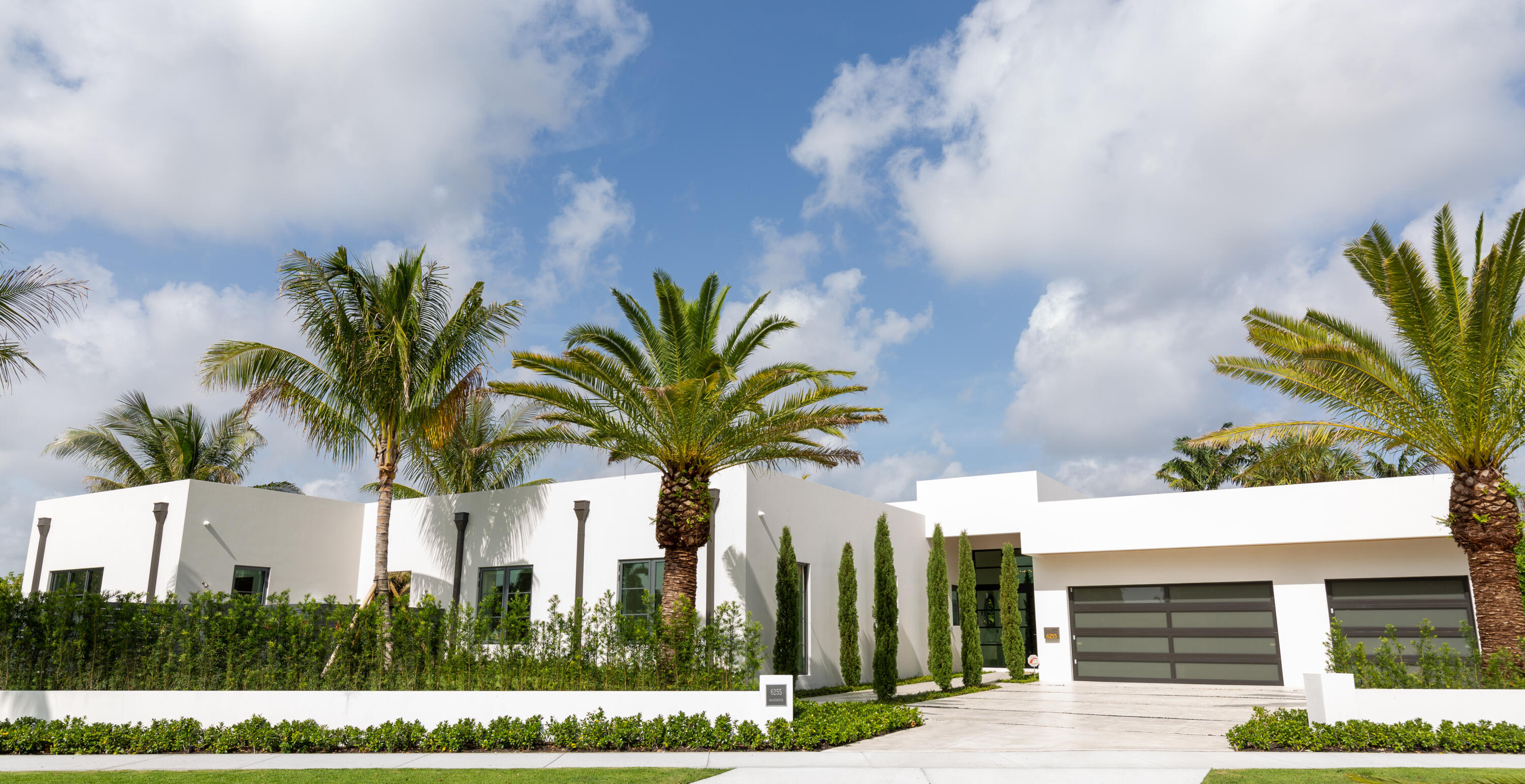 Experience luxury living in this custom one-story home on a +/-17,000 sqft lot on this Intracoastal, east of Olive Ave block. This contemporary masterpiece features 3 bedrooms in the main house, plus a separate guest cottage for added versatility. As you enter, you'll be greeted by exquisite cypress ceilings and soaring ceilings that create an open, airy atmosphere. Enjoy resort style living with a large, heated pool. Car enthusiasts will appreciate the 3-car garage. Designer finishes and clean lines throughout add a touch of elegance. Entertain and dine al fresco in the covered loggia with a summer kitchen. Additional features include, Outdoor shower, covered loggia with retractable electric screens and private sitting room off of the primary suite.