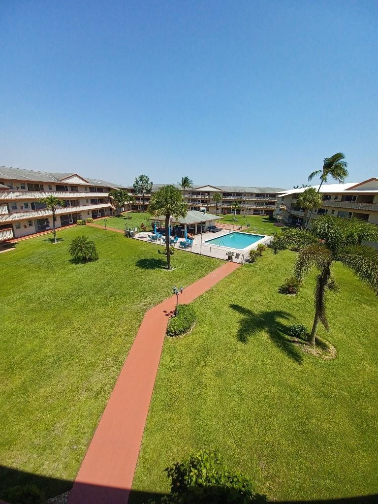 Corner unit gated 55+ community, great view of pool (each building has it's own). Passed 50 year inspection, adequate money in reserves. Five miles from beach and boardwalk. Two miles from Hardrock Guitar Hotel featuring A-list celebrity performances. Small town feel with close proximity to I-95, FL TPKE, and I-75, as well as a 15 minute drive to FTL Airport and 30 minute drive to Miami Intl. Hurricane windows, tankless water heater. Elevator. On-site gym. Large storage locker. Community and surrounding quiet with green spaces. Quick access to major shopping and vibrant downtown in a city that just keeps getting better.HOA will be reduced by $35 next year due to assessment being fulfilled.  Internet is included with HOA.