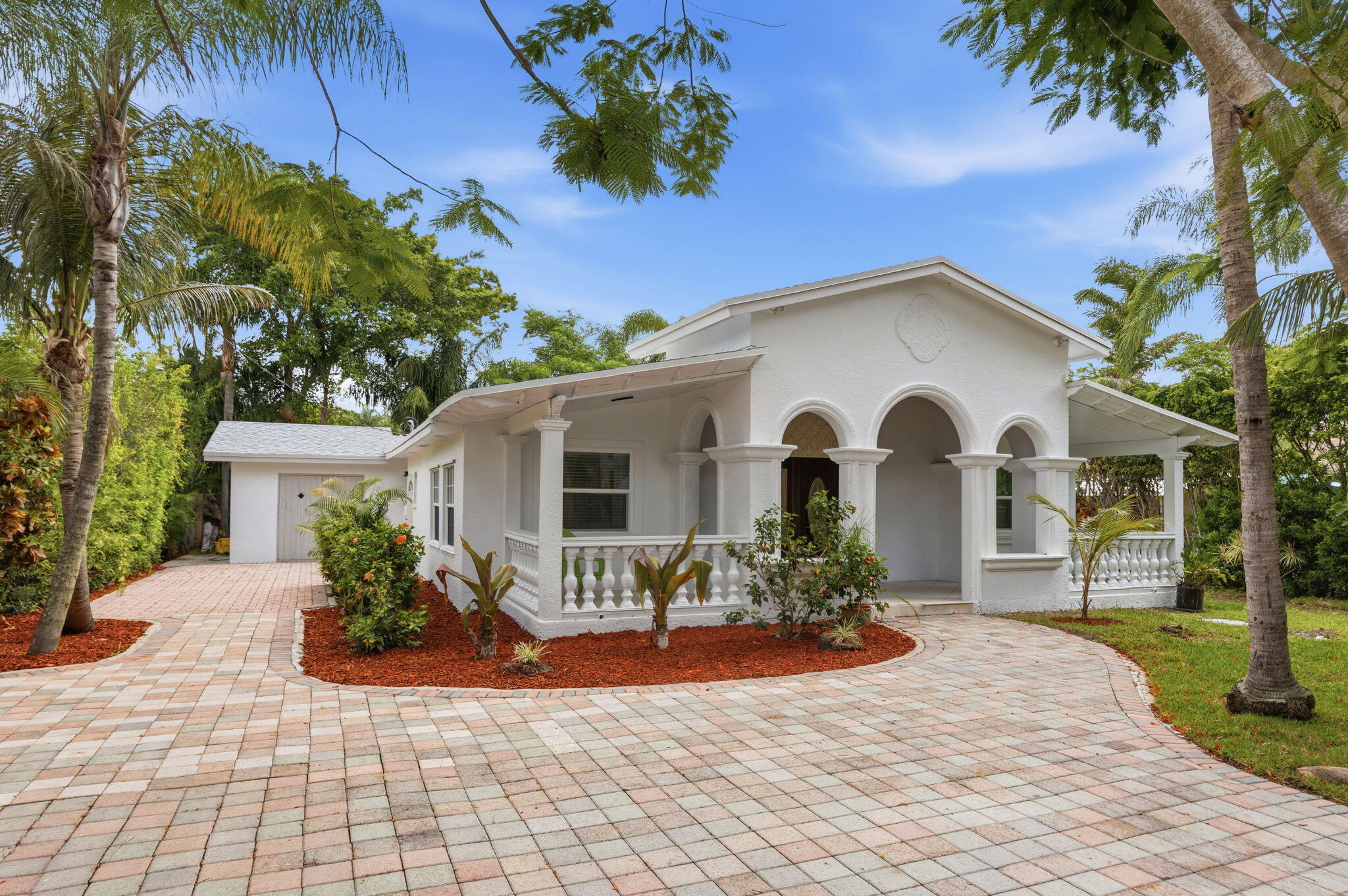 Beautifully updated residence in the highly desirable Roseland Park neighborhood of West Palm Beach. Full of character and unique architectural details, this residence radiates charm and an inviting energy that is truly rare to find. Nestled on a quarter-acre lot with over 2,600 square feet of living space, this hidden gem offers both privacy and comfort. Recent improvements include a new roof, newer air conditioning system, fresh paint, updated countertops, energy-efficient LED lighting, beautifully renovated bathrooms, and a professionally renovated garden, providing both peace of mind and enhanced outdoor enjoyment.  Designed for flexibility and convenience, one of the guest suite bedrooms features its own private exterior entrance, making it ideal for guests, extended family,  a home office, or potential multigenerational living arrangements. From the moment you arrive, the lush, mature landscaping and redesigned garden create a serene retreat and the perfect backdrop for holidays, family gatherings, and special celebrations.  With no HOA restrictions, you'll have plenty of space to store your boat, RV, or other recreational vehicles with ease. Conveniently located just minutes from I-95 and Florida's Turnpike, this exceptional property offers easy access to upscale dining, shopping, and entertainment. Enjoy being only minutes from Downtown West Palm Beach, Palm Beach Island, pristine beaches, and all that South Florida living has to offer.