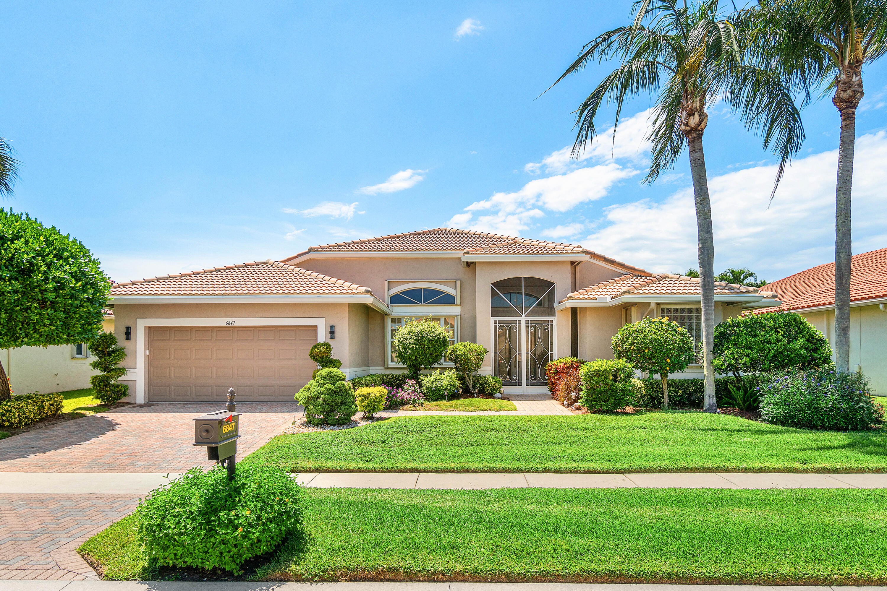 This home is in pristine condition and move-in ready! Exceptional lot sitting right on the Westchester Country Club golf course with breathtaking sunset views. Offering a heated screened pool, spacious outdoor living area, large office, impact-rated add-on sunroom, custom entertainment wall, and an updated kitchen with a redesigned island and updated appliances. Major improvements include a newer roof, additional half bathroom, two A/C units, 2020 water heater, impact front doors, and full hurricane protection. This home is located within walking distance of the clubhouse where you will find the newly renovated cafe, pickleball, tennis, card rooms, an auditorium, and more. Come see it for yourself!