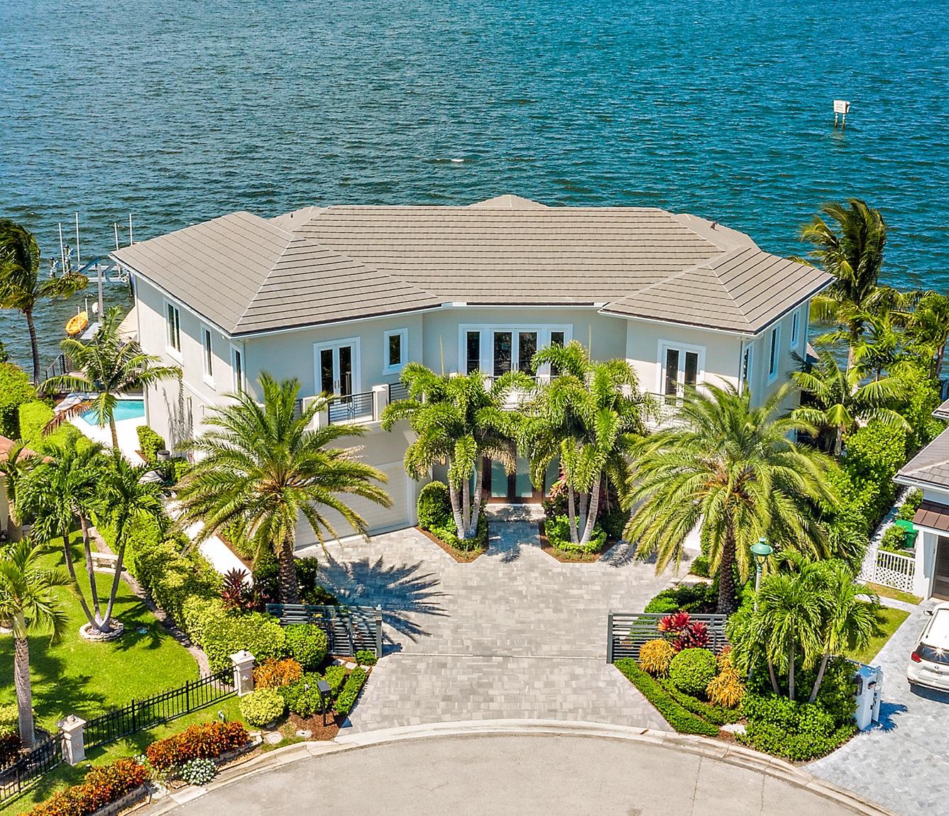 Breathtaking panoramic views of the Singer Island Intracoastal Waterway from this opulent waterfront estate. Located on a gated, point lot on a private cul-de-sac, this newly-built transitional home features 144 ± feet of direct intracoastal frontage and almost 4,200 SF of living area with 4 bedrooms, 5 full, 2 half baths and an air-conditioned 3 car garage. Bathed in natural light and surrounded by windows and balconies, this exceptional home offers an unparalleled opportunity to experience waterfront living. This home was professionally designed and decorated for luxurious coastal living with only the finest of craftsmanship and attention to detail at every turn. See more... Breathtaking panoramic views of the Singer Island Intracoastal Waterway from this opulent waterfront estate. Located on a gated, point lot on a private cul-de-sac, this newly-built transitional home features 144 ± feet of direct intracoastal frontage and almost 4,200 SF of living area with 4 bedrooms, 5 full, 2 half baths and an air-conditioned 3 car garage. Bathed in natural light and surrounded by windows and balconies, this exceptional home offers an unparalleled opportunity to experience waterfront living. This home was professionally designed and decorated for luxurious coastal living with only the finest of craftsmanship and attention to detail at every turn. 

Stunning Chef's kitchen features paneled, high-end appliances including an oversized Sub Zero fridge, Thermador induction cooktop, single oven, warming drawer and two refrigerator drawers. Large island features a quartz top with an additional area for waterfront seating. The 54" sleek custom cabinets create a bold statement in this fabulous kitchen.  Enjoy the magnificence of South Florida sunsets on the water every day from almost every room in the home. The balcony off the upstairs master suite offers a particularly impressive, expansive view of the waterway. Inside, the master suite is equipped with a morning bar, sitting area, separate his and hers fabulous bathroom suites, both with large custom closets. Downstairs, your guests won't want to leave the comforts of their VIP suite on the first floor with their amazing views of Munyon Island. Upstairs you will also find two on-suite bedrooms, a spacious laundry room, reading area and a mahogany-wrapped elevator. 
Masterfully custom-built by the prestigious team of Wilbur Hobgood Construction with a sleek design boasting sophisticated finishes and technology throughout including an electric glass fireplace, expansive living area with soaring ceilings, controlled window coverings, impact glass, security monitoring with 6 cameras, surround-sound and Sonos for the exterior and master bedroom, LED lighting throughout, intricate coffered ceilings, elegant crown molding, 9" baseboards, lush landscaping showcasing Sylvester Palms and triple foxtails as well as extensive landscape lighting, two A/C units with a special distribution system whereby each room can be thermostatically controlled as well as a myriad of other useful features. 

Located on the finest street on Singer Island, this home offers sensational sunsets and incredible views across your waterfront dock and newly reinforced seawall located in the wide section of the intracoastal waterway. The dock features a 20,000 lb lift (which can accommodate up to a 40' boat) as well as an additional lift for kayaks and jet skis. Take a dip in your sparkling plunge pool with a JetStream system and color-changing LED lighting. Savor the aroma of BBQ on your outdoor, built-in grill while being protected from the elements under your covered patio. Enjoy an easy and relaxing short ride to the open ocean. Come see this waterfront masterpiece which is now being exclusively offered.

About Singer Island:
Singer Island is one of the most sought after locations for those looking for both intracoastal and ocean views.  Singer Island features over seven miles of pristine beaches, custom homes, upscale hotels and resorts. The island (actually a peninsula) offers a relaxing blend of natural beauty with just a short ride to both Phil Foster Park & John D. MacArthur State Park which features picturesque beach, snorkeling, scuba diving, hiking and biking trails, mangrove forests and other natural wonders for the nature lover. Singer Island's world-class fishing, boating, science museum, parks and marinas are just a few of the reasons it is chosen by those wanting this amazing lifestyle.  It offers a wide range of shopping opportunities and some of the finest restaurants within just a 5 minute drive. With just a 20 minute ride to Palm Beach International airport, it is very easy and convenient for frequent travelers.