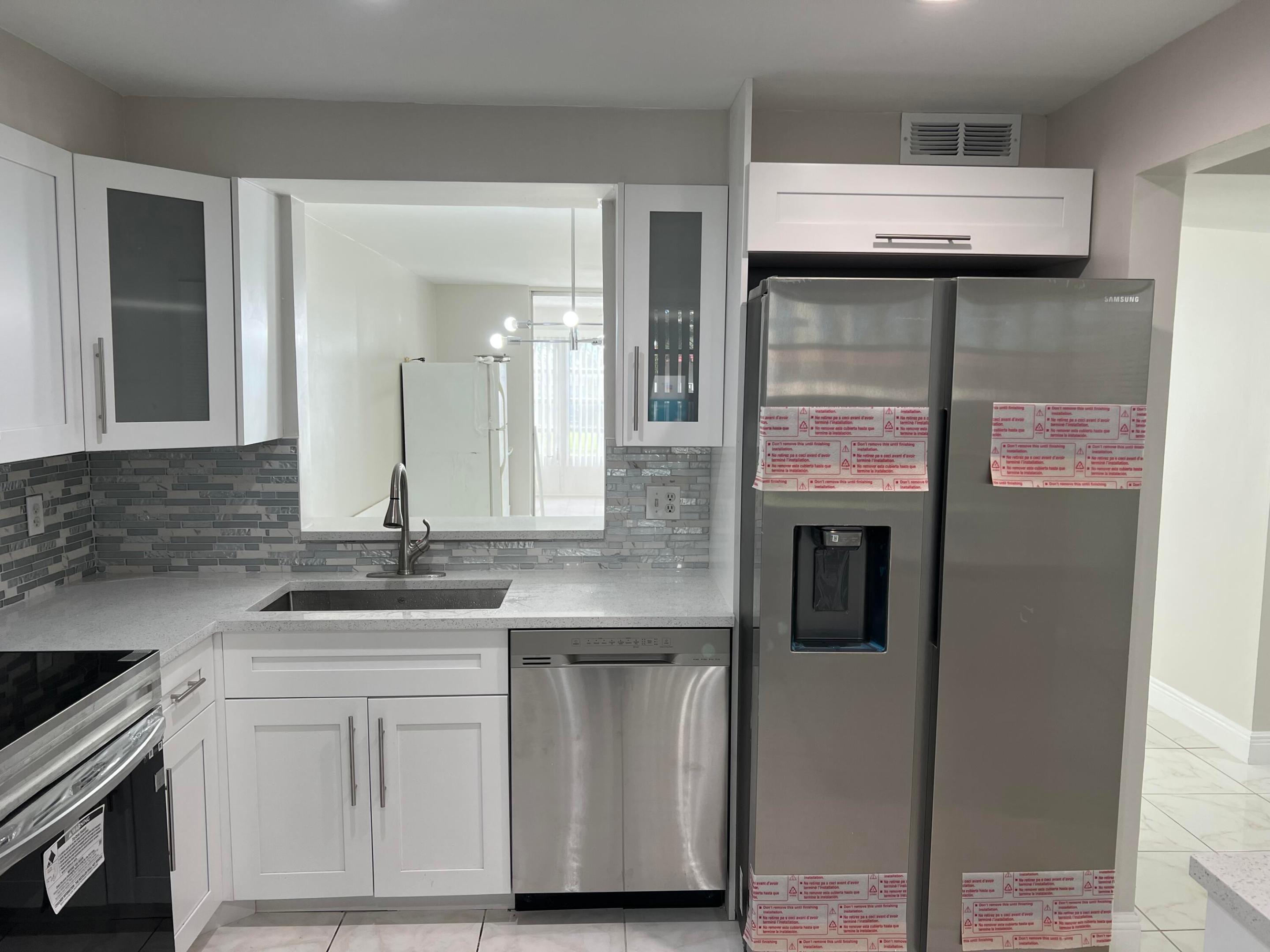 Light and Bright RENOVATED Large 1 bedroom with 2 full baths with step-in showers , unit is next to elevator for easy access. Lake view.Tile throughout. New Open Kitchen, cabinets, with quartzite counters with all new stainless steel appliances, new high hats, New Full size stackable W/D in Kitchen. new H/W heater. New tiled showers, toilets, vanities, mirrors,led daylight lighting, new plumbing. Freshly painted with no popcorn ceilings with new baseboards and ceiling fans in bdr &,livingroom & enclosed patio.Enclosed Patio big enough for an overnight guests .All new window treatments.Walk-in closet in master bedroom. Water, Cable and Internet is included. Clubhouse with pool, theater,gym, sauna ect. Close to shopping, restaurants, I-95 and Turnpike and walk to House of Worship.
