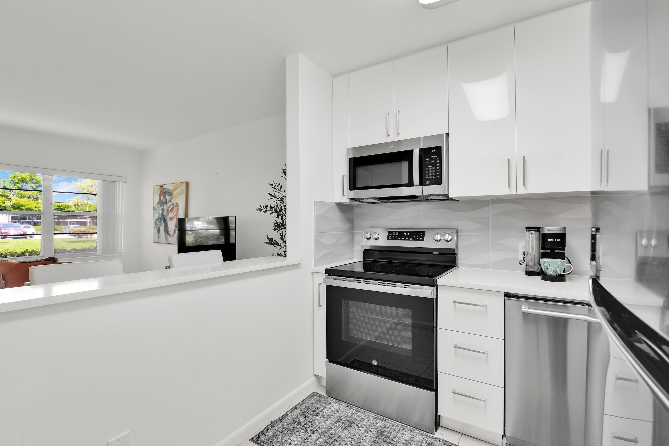Beautifully renovated first-floor residence with breathtaking lake views and exceptional finishes throughout. This spacious 1-bedroom, 1-bath home features a screened-in patio overlooking the tranquil lake, creating the perfect setting to relax and enjoy the scenery. The contemporary kitchen opens to the living area through a convenient pass-through and boasts quartz countertops, sleek high-gloss white cabinetry, and stainless-steel appliances. The designer bathroom is appointed with modern tilework and an elegant floating vanity. Enjoy resort-style living with an impressive array of community amenities designed to support an active and social lifestyle. Whether you're seeking a seasonal getaway or a full-time residence, this move-in-ready home offers comfort and style