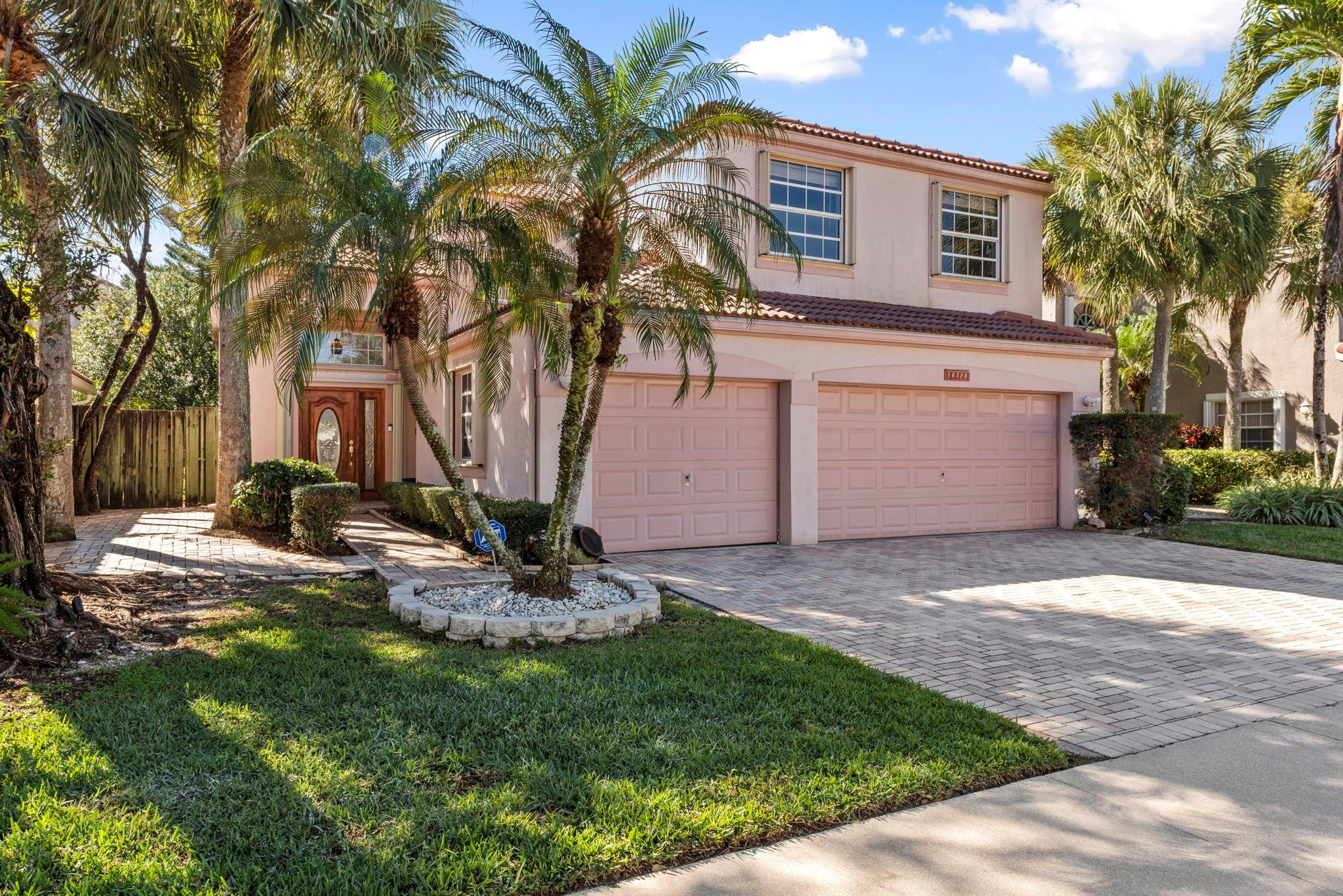 This light-filled home welcomes you into a spacious living room with soaring, voluminous ceilings and a freshly painted interior. Offering 3 bedrooms, 2.5 baths, plus an office/den that can easily convert into a 4th bedroom.  The layout is both flexible and functional. Enjoy abundant parking with a beautifully pavered driveway, entry walkway, and fenced backyard—perfect for low-maintenance outdoor living with exceptional privacy. Additional highlights include accordion shutters, ample storage throughout, and an interior laundry room with newer washer and dryer. Located in a beautiful community close to the lakefront pool and city park, this home blends comfort, convenience, and lifestyle.