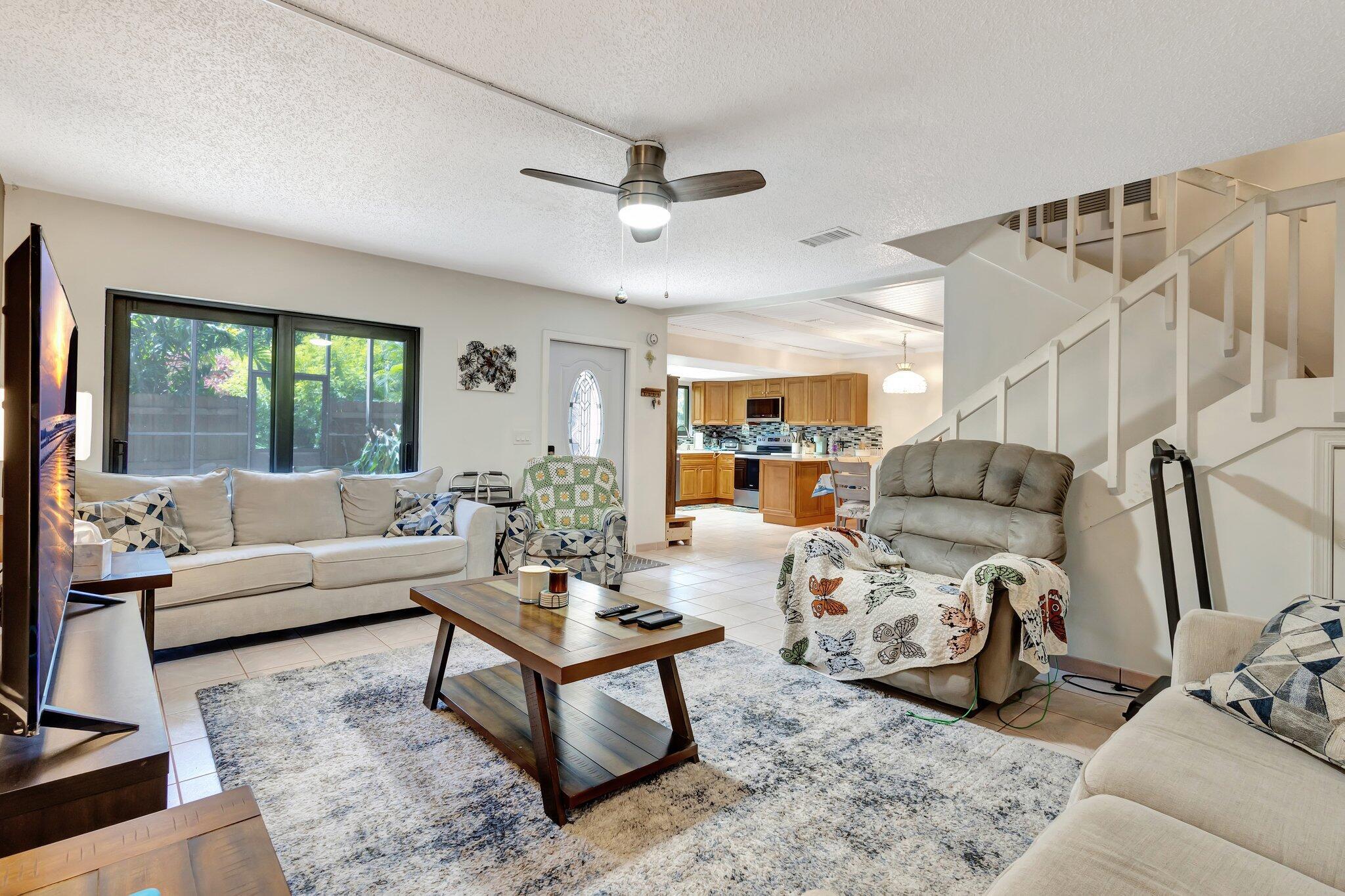 Perfect private oasis. This 3/2.5 with screened patio (screened in to the top townhouse) is beautifully landscaped. ***NEW: Laminate flooring on stairs and 2 bedrooms., kitchen countertops, stove, microwave, dishwasher (2023) and refrigerator (2024). Also new, washer and dryer (2023), all ceiling fans, toilets and ring camera. Tinted sliders for extra privacy and coolness. Come see for yourself.