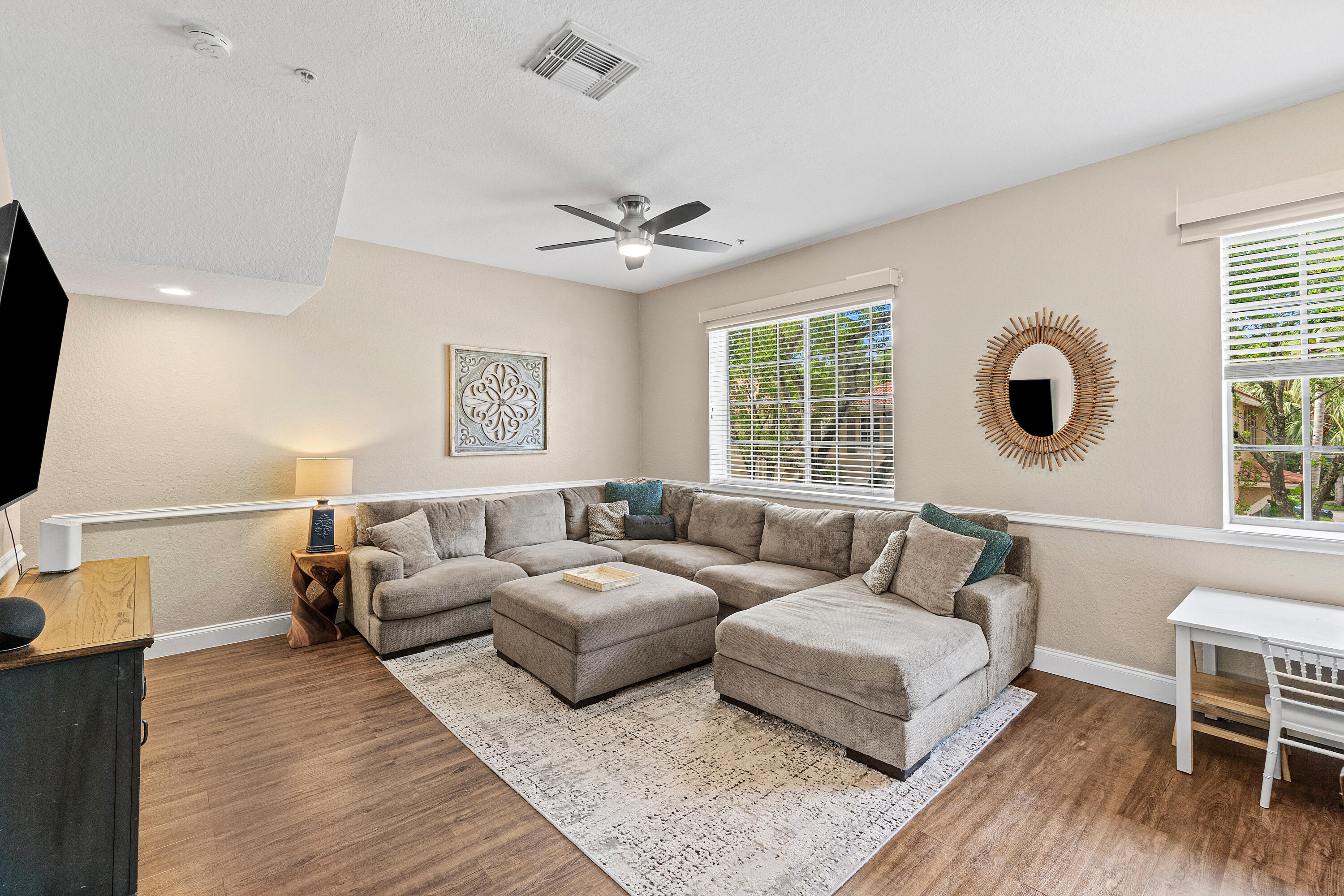 Welcome to this beautifully maintained three-story townhome nestled in one of the area's most charming communities. Surrounded by lush landscaping, tree-lined streets, and picturesque neighborhood parks, this residence offers the perfect blend of comfort, style, and convenience. The first floor features a spacious two-car garage and a versatile guest bedroom or home office. Upstairs, the main living level is bright and inviting, showcasing high ceilings, an open-concept design, and a modern white kitchen complete with stainless steel appliances, quartz countertops, a large pantry, and covered balcony. A convenient powder room completes this level, making it ideal for both everyday living and entertaining.  The third floor offers three bedrooms, including a spacious primary suite with dual closets and a newly renovated primary bathroom. The two guest bedrooms share a well-appointed full bath, while the upstairs laundry room adds everyday ease and convenience. Combining thoughtful updates, functional living spaces, and an exceptional neighborhood setting, this is a place you'll be proud to call home.