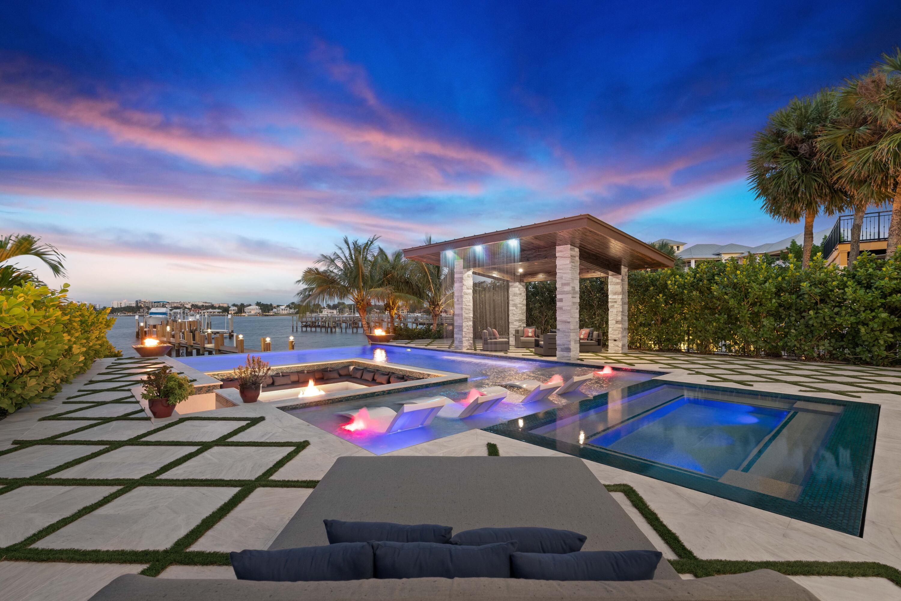 New construction waterfront paradise on the direct Intracoastal within a 10 minute walk to the beach! Indoor/outdoor living with 32' by 10' tall pocketing sliders leading to the expansive pool and patio. This resort style back yard offers a Sunken fire pit, infinity edge pool and spa plus covered gazebo with swim-up bar stools and waterfall behind create the perfect space to entertain. Water views from nearly every room! Grand master suite on the upper level with additional bedroom or home gym. Guest rooms on first floor or use as a study, media room or game room. Over sized garage plus second driveway along the north side for trailer or boat parking. Walking distance to Oceano Kitchen, The Eau resort and spa and other area restaurants and just minutes to the beach.