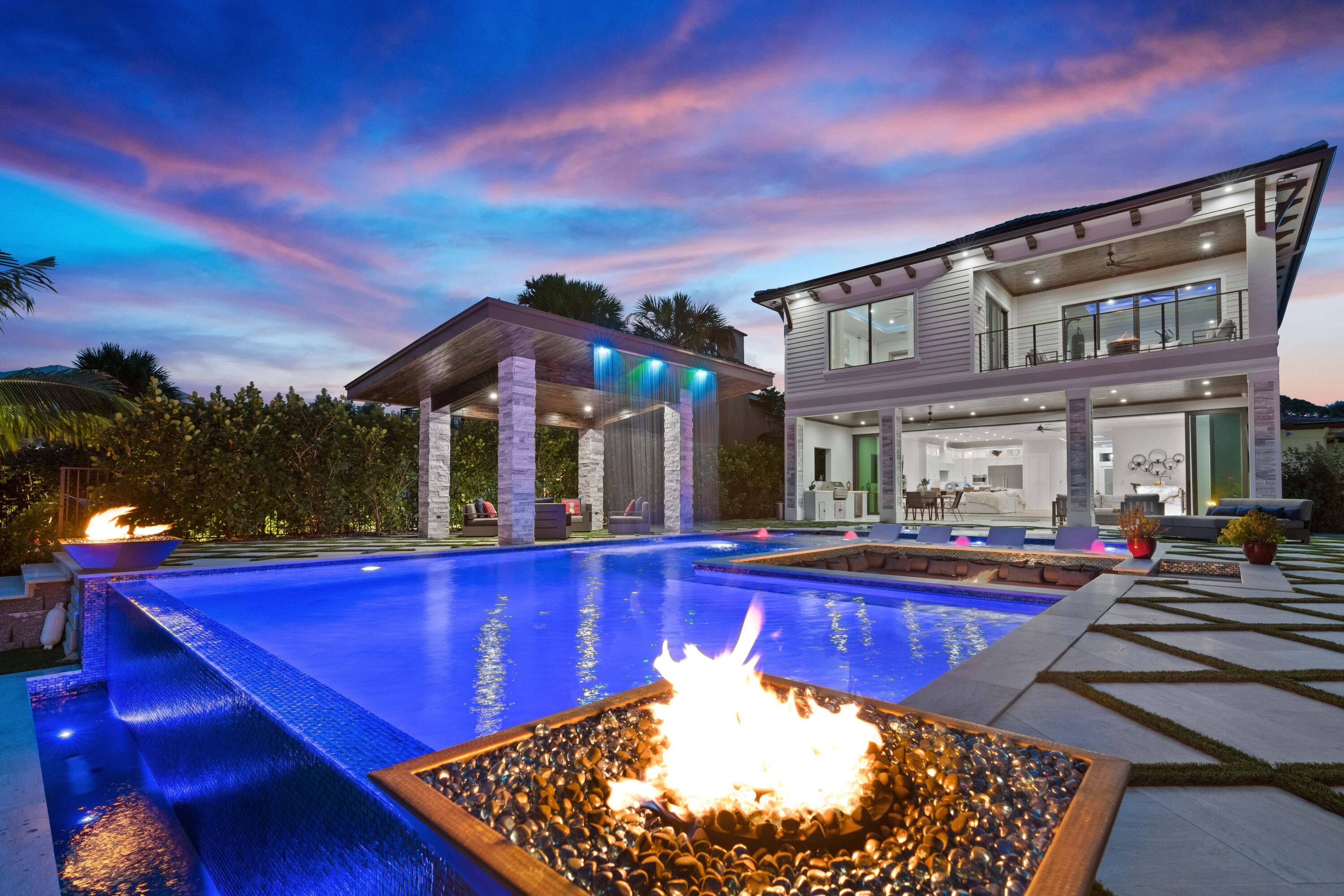 New construction waterfront paradise on the direct Intracoastal within a 10 minute walk to the beach! Indoor/outdoor living with 32' by 10' tall pocketing sliders leading to the expansive pool and patio. This resort style back yard offers a Sunken fire pit, infinity edge pool and spa plus covered gazebo with swim-up bar stools and waterfall behind create the perfect space to entertain. Water views from nearly every room! Grand master suite on the upper level with additional bedroom or home gym. Guest rooms on first floor or use as a study, media room or game room. Over sized garage plus second driveway along the north side for trailer or boat parking. Walking distance to Oceano Kitchen, The Eau resort and spa and other area restaurants and just minutes to the beach.