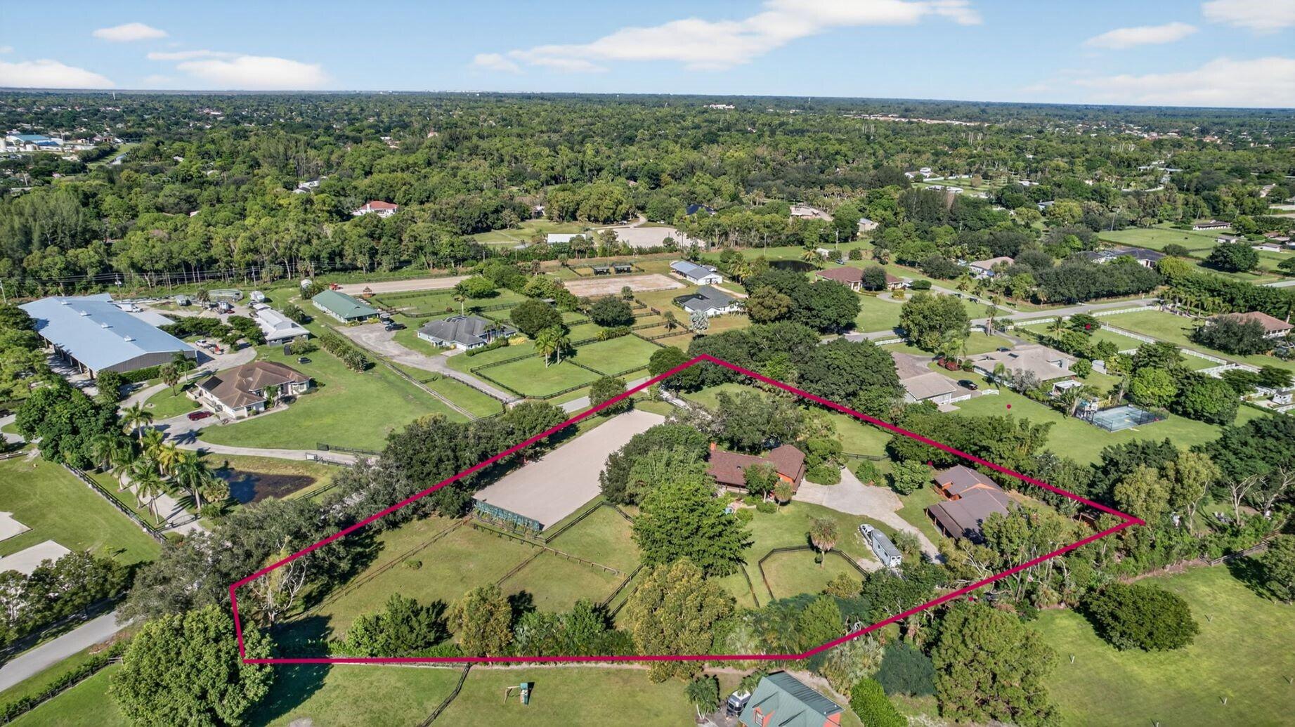 Welcome to your own equestrian retreat -- an established, beautifully appointed 3-acre farm. Train & ride at home in the dressage ring w/ mirror wall and charming viewing gazebo, then turn your horses out to 8 lush grass paddocks.  Thoughtfully designed 12-stall barn features a dedicated stallion stall, automatic waterers, 2 wash racks, tack room w/ 1/2 bath, feed room, washer & dryer.  A charming 3-bedroom, 2-bath main residence w/ impact windows awaits, where a dramatic floor-to-ceiling coral fireplace creates a warm, inviting focal point. Relax on the expansive screened porch overlooking the newly refinished pool, perfect for unwinding after a day in the saddle or entertaining friends under the stars. A breezeway connects the barn to a spacious 1 bedroom apartment. Offered Turnkey.