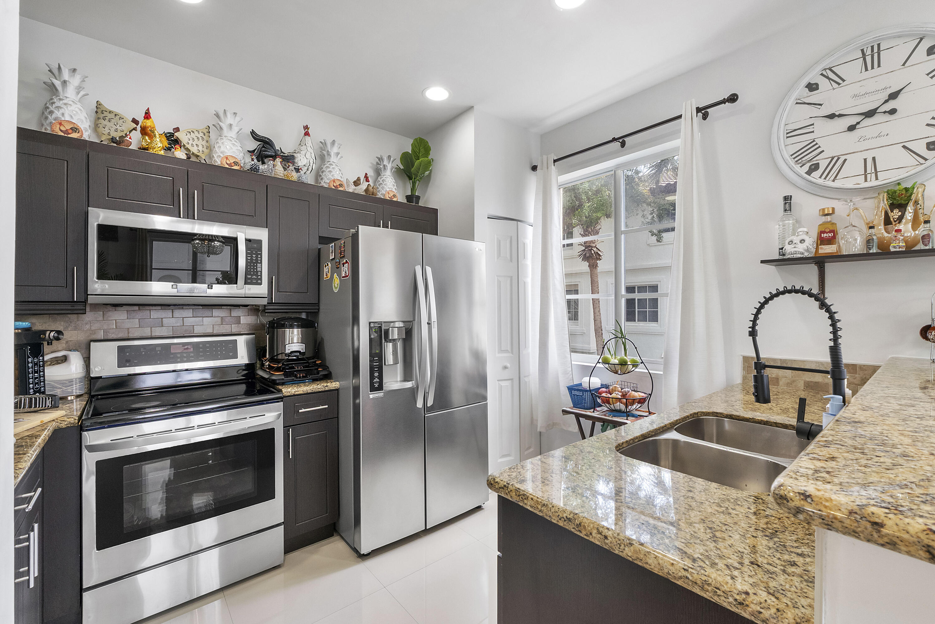 Move-in ready and beautifully maintained, this 3-bedroom, 2.5-bath multi-level townhouse is located in the highly desirable Boardwalk at Vizcaya community and is perfect for both owner-occupants and savvy investors. Filled with natural light, the home features an open-concept living area, granite countertops, stainless steel appliances, bar seating, and a spacious pantry. The primary suite offers a walk-in closet, double vanity, frameless glass shower and separate soaking tub. Major upgrades include a NEW ROOF (2025)  IMPACT WINDOWS, and NEW A/C (2024) Fannie Mae approved condo! Residents enjoy resort-style amenities including a clubhouse, pool area with lounge seating, gym, pet grooming station, & lush landscaping! Property can be financed with 5% down, more than 10% on reserves!