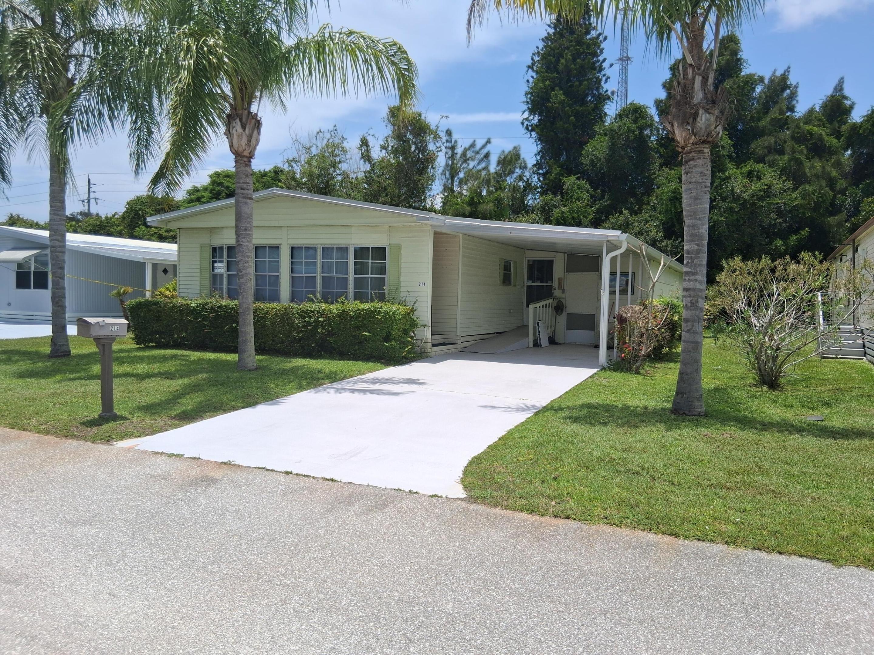 Spanish Lakes Golf Village, a 55+ community with resort-style amenities 1980 Model Move in ready 2-bedroom, 2-bath home. Fully enclosed garage work space. A new metal roof (2020), hurricane shutters, tie-downs, and new A/C system for peace of mind. Bright, functional layout with spacious living and dining areas. Monthly land lease includes access to community amenities like golf, swimming, tennis, and clubhouse activities. Park approval required. Ideal for seasonal or full-time Florida living in a friendly, well-maintained community. BK Grade 8 of 10 subject to contactor finishing kitchen remodel and cleanout Fair market value 12 months ago $60,000. Market rent for this property is$ 930.98 a month for 12  months if purchased by 6/30/26. AFTER July1 will be $991.51 a month for 12 months.