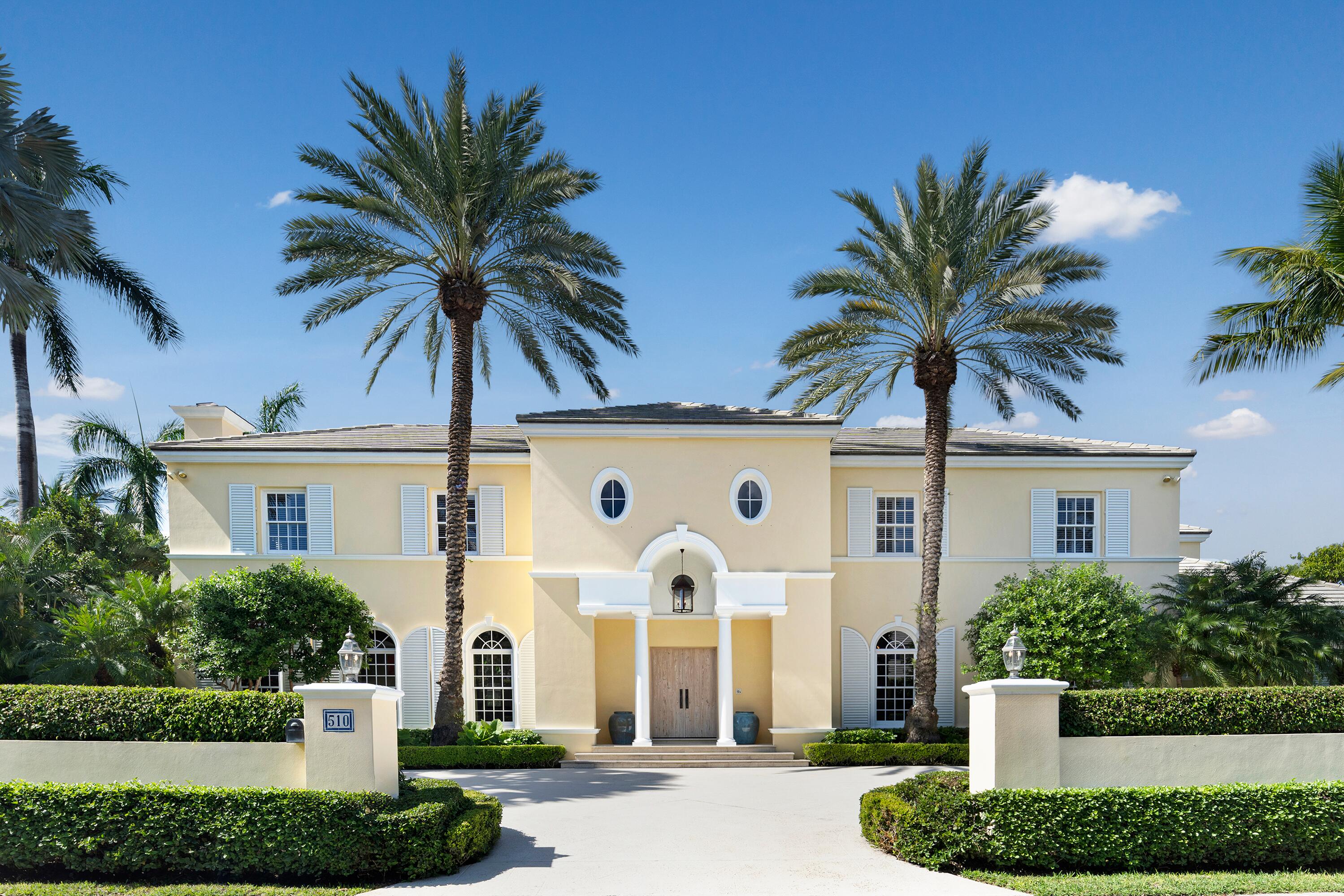 This British Colonial residence offers 6,922± total square feet with five bedrooms and six and a half bathrooms. Set on a 100' x 172' lot at the corner of Tangier Avenue and North Lake Way, the property features a large pool, covered loggia, and beautifully maintained grounds.  The spacious foyer opens to the formal living room and a central gallery hall that connects the main living areas. The family room, located on the south side, opens through French doors to the covered loggia and pool. On the north side, the gallery leads to the formal dining room, library, and kitchen with adjoining dining area—an ideal layout for both everyday living and entertaining.  Two guest bedrooms are located on the first floor, each with en suite baths and walk-in closets—one currently serving as a library. Additional first-floor features include a powder room, laundry room, and a two-car garage with separate service drive.  Upstairs, the primary suite offers exceptional space and privacy with four walk-in closets, dual bathrooms, and ample storage. Two additional guest bedrooms on this level each include en suite baths and walk-in closets.  Ideally situated on Palm Beach's North End, the residence is just moments from the Lake Trail, beaches, restaurants, and world-class shopping.