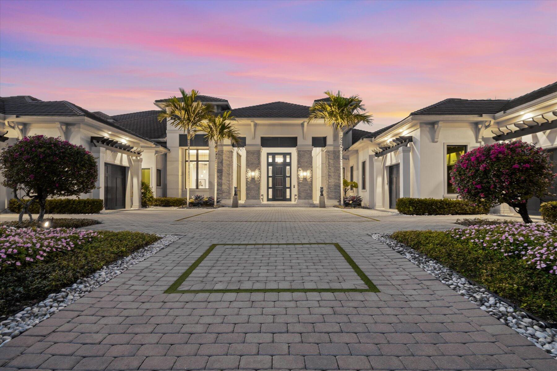 This exquisite custom estate home, nestled within the prestigious private enclave of Cypress Island in the Palm Beach Polo and Country Club, epitomizes luxury living at its finest. Spanning over an opulent layout with nearly 7,000 SF of living space, this residence boasts five bedrooms and five full baths, complemented by two half baths, more than 1,000 SF of screened outdoor living space and accommodates four vehicles comfortably with oversized garages, plus room for golf carts.As you step inside, you are greeted by soaring high ceilings of the formal living room and its beautiful views of the fountains and infinity edge pool. The east wing begins with a spacious office adorned with meticulous custom woodworking, reflecting the home's attention to detail throughout. The grandeur extends into the large master suite, a sanctuary featuring a coffee bar, Subzero fridge, sitting area, and two expansive walk-in closets with custom built-ins and island with luxurious storage. Floor-to-ceiling windows offer serene views of the pool area and a private loggia, adding an intimate outdoor retreat. The master bath is a masterpiece of luxury, featuring a double walk-in shower with multiple shower heads, a stunning oval hammered freestanding soaking tub, and dual vanities with dual water closets.
The elegance continues with a formal dining room, a temperature-controlled wine room, and a butler's pantry, equipped with Subzero beverage fridge and ice-maker, leading to a gourmet kitchen. This culinary haven is outfitted with top-of-the-line Wolf and Subzero appliances, custom cabinetry, quartz countertops, and double dishwashers. Open-concept Great Room includes expansive pocketing glass sliding doors that open up entirely, creating unobstructed views and access to the backyard through the outdoor living space. The west wing of the home boasts the four additional bedrooms, all including en suite bathrooms, walk-in closets, culminating with a VIP guest suite located upstairs, complete with a wet bar and private terrace. Outdoor living is equally impressive, featuring a summer kitchen, including Wolf gas grill, Subzero fridge and ice-maker, pool bath, gas fireplace, and remote-controlled retractable screen enclosures. The saltwater heated pool, complete with fire features and spa, along with an intimate fire pit area, offers a luxurious oasis for relaxation or entertaining. Ensuring peace of mind and privacy, the property is fully-fenced and the home is secured by its own private electric gate and is equipped with a full-home generator. Control4 home automation technology delivers a "Smart Home" experience for everything from music to lighting to home security system and is controlled by the push of a button or an app on your phone from anywhere in the world. This property is a true gem, offering an unparalleled blend of luxury, comfort, and security in one of the most coveted locations in Palm Beach Polo.
