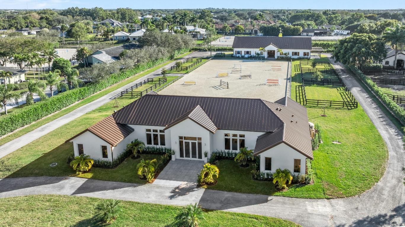 A Newly Built Equestrian Estate of Exceptional Distinction
Introducing a rare opportunity to own a masterfully crafted equestrian estate set on more than 2 acres in one of the area's most sought‑after locations. This newly constructed compound blends architectural sophistication with world‑class equestrian amenities, creating a property that stands in a class of its own. The residence offers four beautifully appointed bedrooms, each with its own ensuite bath, designed to deliver refined comfort and privacy. An expansive open layout, dramatic ceiling heights, and walls of glass frame sweeping views of the 115' x 210' riding arena and the impeccably designed barn, bringing the equestrian lifestyle into every moment of the home.
The 10‑stall barn is built to the highest st featuring wide aisles, a stylish rider's lounge, full bath, dedicated tack room, laundry, two wash stalls, an airconditioned feed room, and separate hay storage with exterior loading. Every detail reflects thoughtful planning and premium craftsmanship.
Dual gated entrances provide both privacy and convenience, with distinct access points for the residence and the barn, enhancing the estate's seamless flow and sense of exclusivity.
This is more than a property  it is a statement of quality, elegance, and equestrian excellence. A newly built estate of this caliber is truly a mustexperience offering.