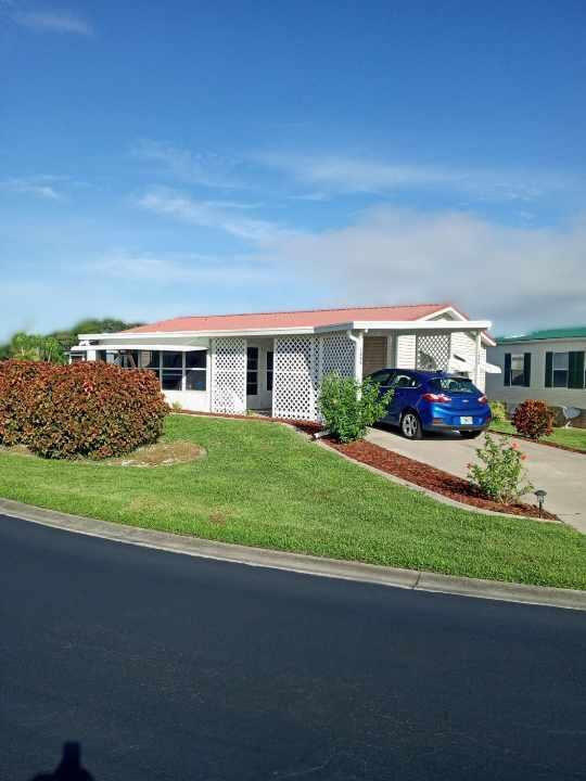 SEMINOLE COVE 2/2Move in Ready.  Furnished with 2 Master suites and all appliances. There are no steps to worry about in this property.  2 entrances with 2 driveways to enter the front sunroom then home.  Large living room and open concept to dining area.  Inside laundry area.  Both master suites have large closets and ceiling fans.  Home has metal roof and storage room.  Corner lot and landscaped with fruit trees and center island.  Seminole Cove is a 55+ community with heated swimming pool, large clubhouse, fish cleaning house, shuffleboard court, trailer storage area and many activities to keep busy.  Gated at dusk for security.  Measure rooms for accuracy