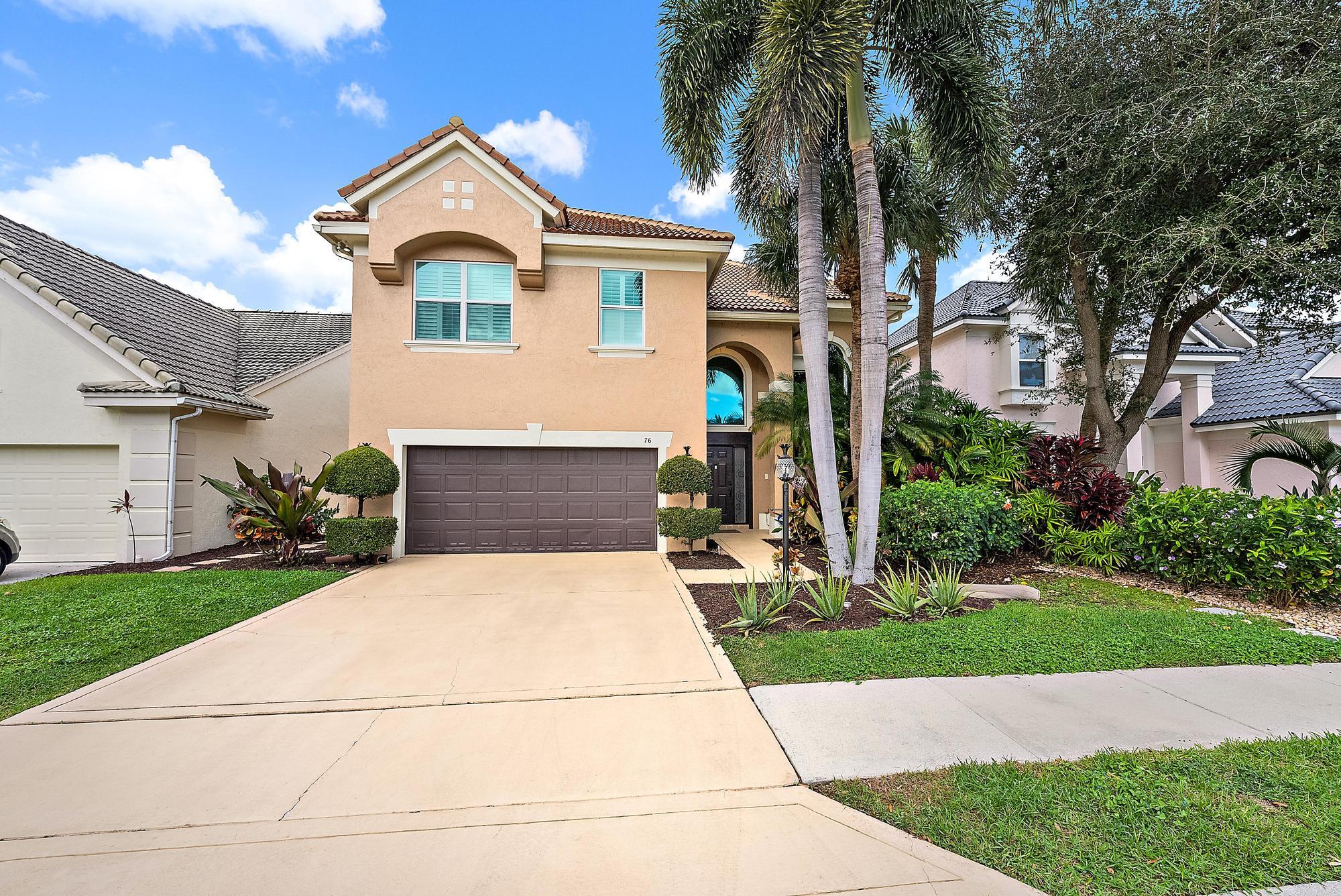 Set within the prestigious gated community of The Sanctuary, this beautifully remodeled 4-bedroom, 2.5-bath Mahogany model offers refined luxury and tranquil lake views. Impeccably maintained and filled with natural light, the two-story residence features 24x24 Saturnia marble flooring, hardwood floors, soaring ceilings, and custom millwork throughout. The gourmet kitchen is designed for entertaining, showcasing handcrafted cabinetry, granite countertops, and top-of-the-line appliances including a 48-inch Thermador gas range. All bedrooms are located upstairs, highlighted by a spacious primary suite with serene lake views. Outdoor living is elevated with a heated saltwater pool, expansive stone paver patio, and fenced yard. Recent upgrades include a new roof (2021), impact glass (2022), smart home features, and fresh interior and exterior paint. Ideally located minutes from The Gardens Mall, dining, beaches, and PBI Airport with exceptionally low HOA fees.  76 Princewood Notes: Newly renovated Laundry Room Washer /Dryer  Newly renovated Powder Room  Kitchen: New Wolf 48" stove with griddle Newly renovated kitchen Thermador Dishwasher Kitchen Aid Fridge/Freezer  Family Room: 65" LG TV wall mount (1yr old)  Primary Bathroom: Newly refreshed  Guest Bathroom: Newly refreshed  New ceiling fans and light fixtures throughout  Newly installed ADT alarm system Garage cabinetry and extra Thermador Fridge  New Central ac ductwork March, 2025  Pool-New Salt System April, 2025  EXCLUSION: Tiffany hanging globe in Kitchen All furniture, Art, area rugs, Primary room TV
