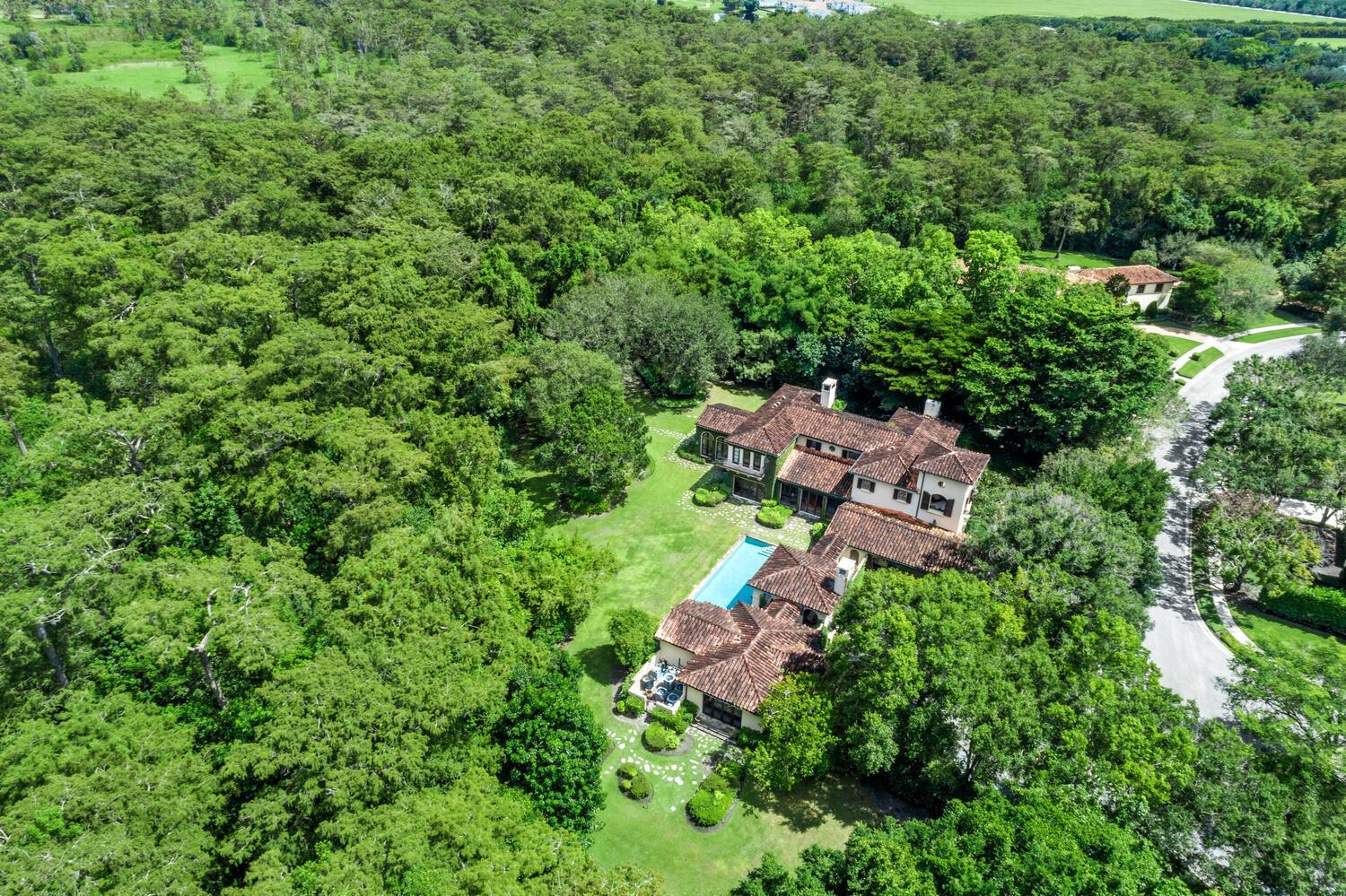 This exceptional residential estate comprises one of the largest lots  (1.15 acres) and is one of only 3 homes in the exclusive Bridle Path neighborhood of Palm Beach Polo to abut the Big Blue Cypress Forest preserve area, offering the utmost in privacy and natural beauty. 

Extensive landscaping improvements were completed that provide incredible privacy, beauty and unparalleled viewsheds of and into Palm Beach Polo's protected Big Blue Cypress Preserve area. All exterior driveway areas are constructed with solid granite pavers and interior walkways are solid limestone and slate.

The home's interiors are exquisitely designed and tastefully appointed with various combinations of limestone, parquet and heart of pine wood, with antique oak, pine and cypress beamed and paneled ceilings and solid mahogany doors all with iron European door handles, and arched passageways.
