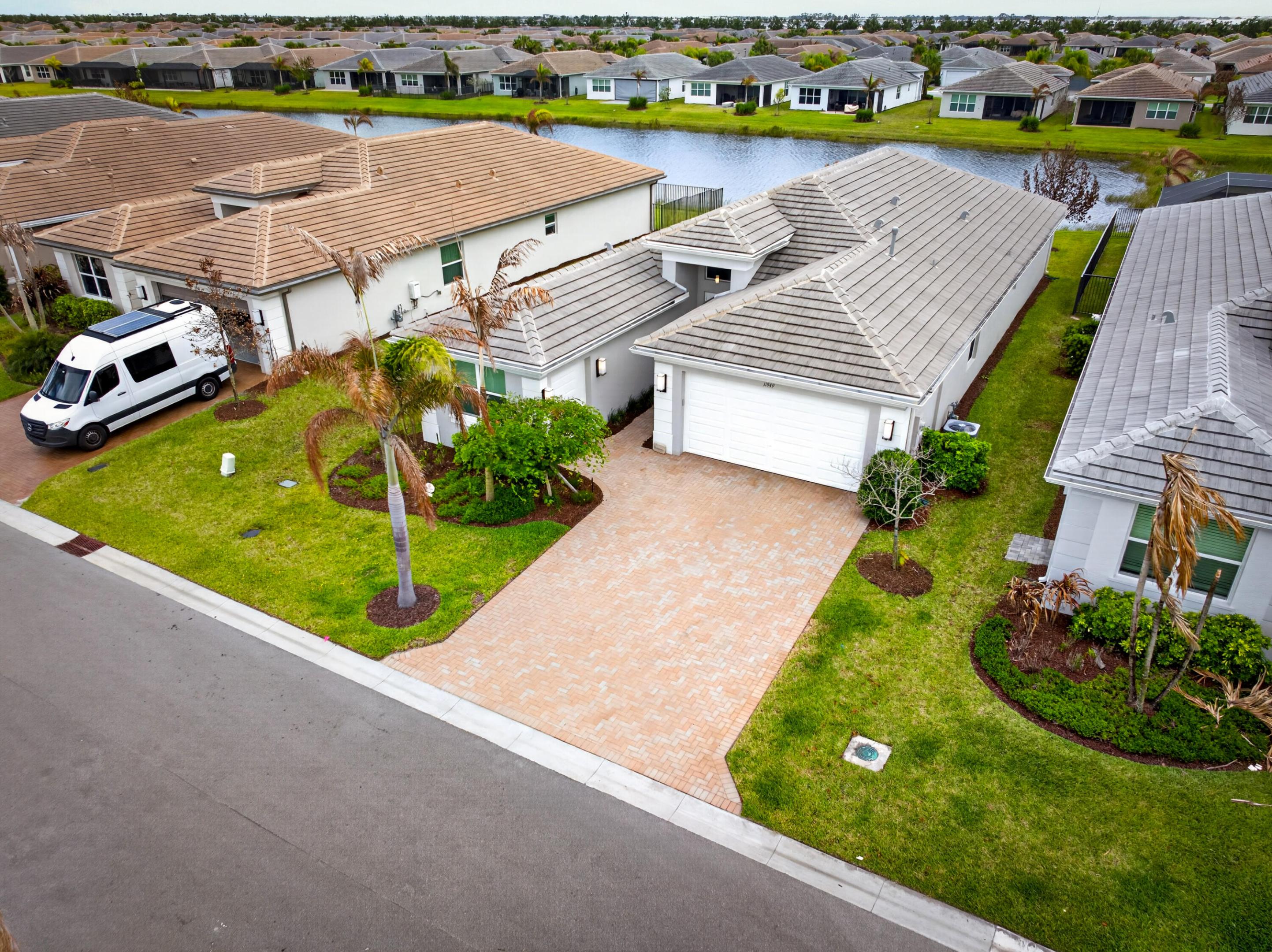 SOLD FULLY FURNISHED! Welcome to this beautifully upgraded lakefront Bimini model in Riverland, offering the perfect blend of luxury, comfort, and true move-in-ready convenience. This 3 bedroom, 3 full bathroom home plus a versatile den is being sold fully furnished, making it an exceptional opportunity to step right into the Florida lifestyle without the time, cost, or stress of building. Positioned on a premium lakefront lot, the home features peaceful water views and a backyard designed for entertaining, complete with an extended screened lanai and a fully equipped outdoor kitchen with a grill, wine fridge, and ample counter space.  Inside, the open concept layout is centered around a bright, spacious kitchen with upgraded cabinetry, quartz countertops,  a large island with seating, stainless steel appliances, a designer backsplash, and a stainless steel hood. The primary suite offers a relaxing retreat with a tray ceiling and a fully customized walk-in closet, while the flexible den with a Murphy bed and closet can easily function as a fourth bedroom or home office. Additional upgrades include tile flooring throughout, crown molding, remote control blinds, upgraded lighting, and enhanced bathrooms with tile extended to the ceiling. The finished garage features epoxy floors, built-in storage, a utility sink, EV charging outlet, and a golf cart garage. With over $94,000 in builder upgrades and extensive post-closing improvements, this home offers a level of finish and value that is truly better than new.