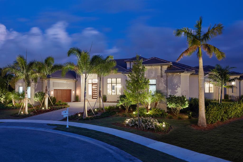 This new construction estate by Stock Custom Homes is located in the private, gated golf community of Palm Beach Polo and boasts a waterfront, 0.6-acre lot that is ideally positioned at the end of a cul-de-sac. The designer pool-home offers over 7,000sf of living space with 5 bedrooms, 5 full and 2 half baths, and a split 5-car garage. The sleek, dynamic interior has been brought to life by the experts at Beasley and Henley Interior Design and is offered fully furnished. Outfitted with elegant furniture and contrasting, unique features, the home creates a tailored yet relaxed atmosphere. Just a few of the luxurious details include lofty tray, coffered and Oak beam ceilings, large-plank Oak wood floors, Wolf/Sub-Zero appliances, marble-tiled baths and quartz countertops. Equally captivating is the backyard oasis; host to a resort-style infinity-edge pool with built-in gas fire features, a spacious spa, an expansive deck with a lounge area and fireplace, as well as a fully-equipped outdoor bar.