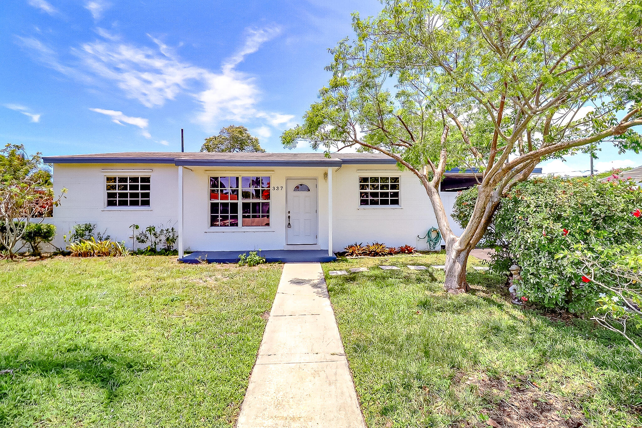 Welcome home to this beautifully maintained 4-bedroom, 2-bathroom single-family residence in the heart of Palm Springs! Situated on a spacious lot with NO HOA, this solid CBS home offers the perfect combination of comfort, functionality, and exceptional outdoor living. Step inside to an open-concept layout featuring tile flooring throughout and an updated kitchen complete with granite countertops, white cabinetry, and stainless steel appliances, creating a seamless flow between the living, dining, and kitchen spaces. Recent improvements include a brand-new central A/C system and new electrical panel for added peace of mind. A dedicated laundry/utility room provides extra convenience and storage. Outside, discover your own private tropical oasis with lush landscaping,a beautiful garden area and a large deck perfect for entertaining, relaxing, or enjoying Florida's year-round sunshine. Fully fenced yard, includes storage shed, outdoor stone furniture, and fountain all convey with the property. With ample room to add a pool, the backyard offers endless possibilities. Located in a fantastic community featuring a brand-new playground, splash pad, pickleball courts, basketball, tennis, baseball fields, community library, and so much more, this home is conveniently close to shopping, dining, schools, and major roadways. Don't miss this rare opportunity to own a move-in-ready home with NO HOA and an incredible backyard in one of Palm Springs' most desirable neighborhoods!