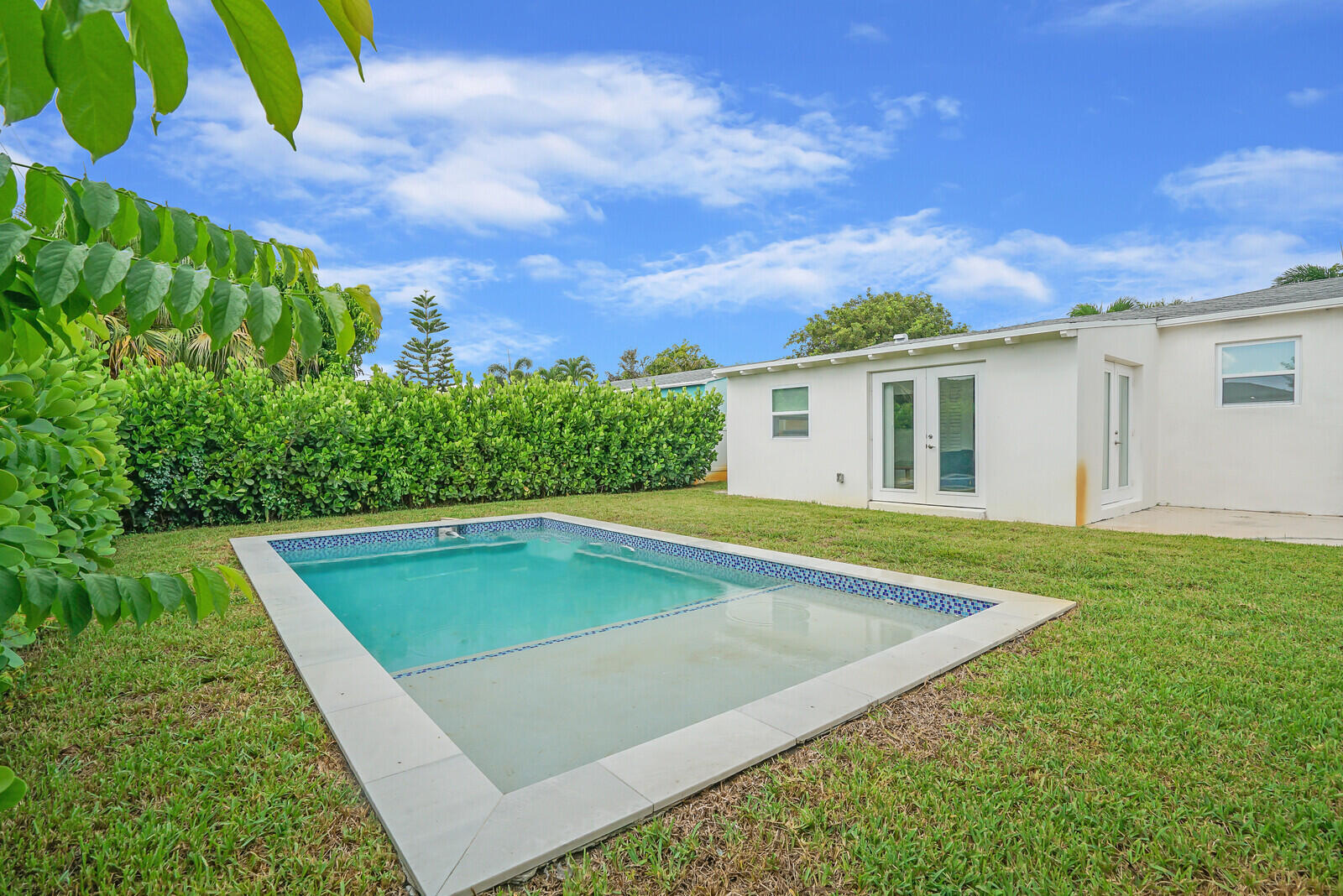 Incredible opportunity to live in the highly sought-after Southend neighborhood (SoSo), just two blocks from the Intracoastal and across from South Olive Park. This charming mid-century CBS Ross home features 3 bedrooms, 2 baths, and a bonus Florida room, offering a cozy and welcoming atmosphere. The renovated kitchen, upgraded floors, and hurricane impact windows add modern touches to this classic home. The private patio with gazebo and brand-new pool create an ideal outdoor retreat, complete with a fenced yard, palm trees, and an outdoor shower. Located in a quiet area, this home is just minutes from shopping, dining, beaches, Downtown CityPlace, and the Island of Palm Beach. This is a place you'll love to call home. Home is equipped with a EV charger. FULLY FURNISHED!