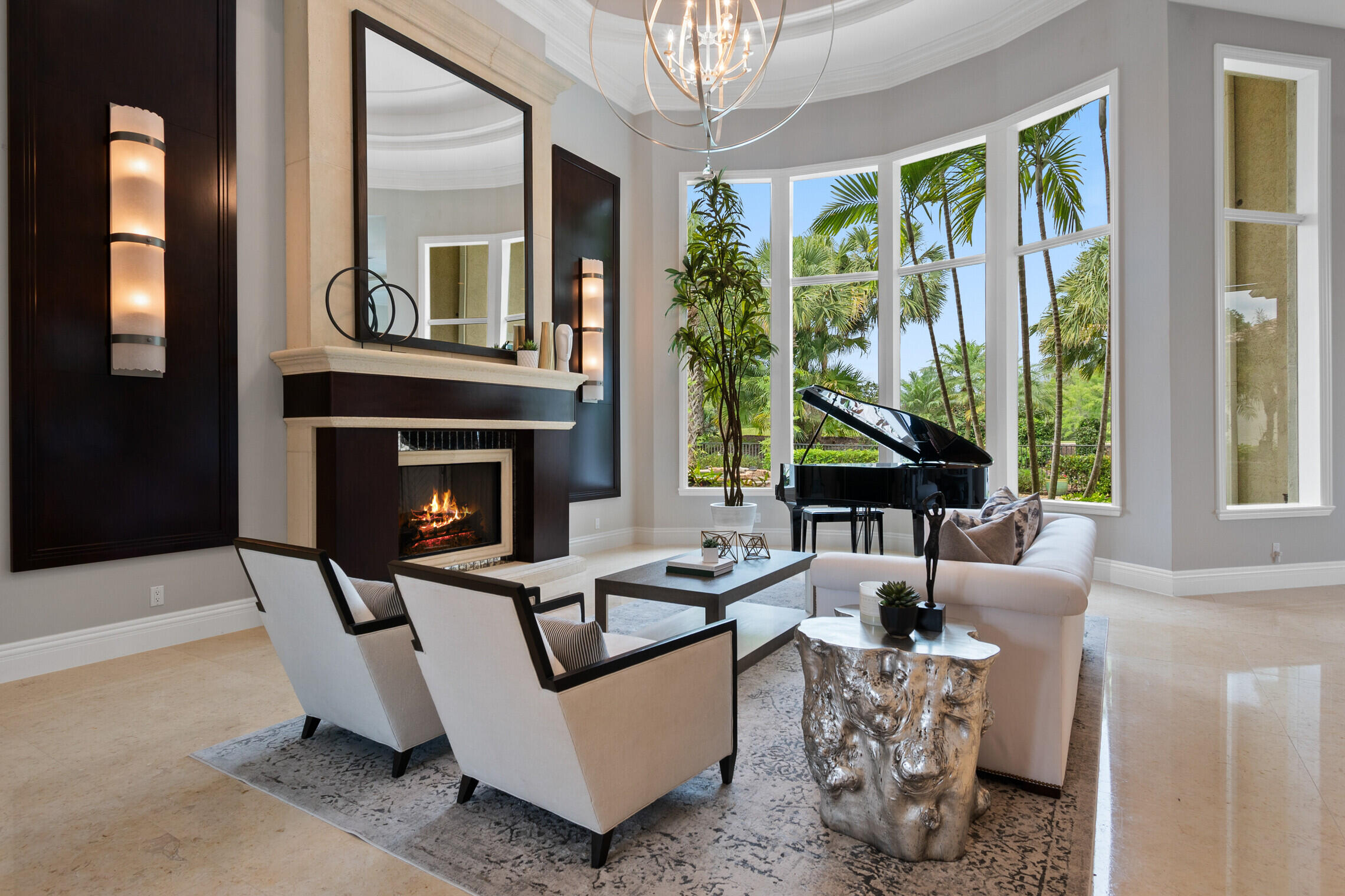 An absolutely stunning home awaits the buyer of this rarely offered 6000 square foot mansion all on one level, built by the renown Florida luxury home builder, Mustapic Homes. This home is located in Mirasol Country Club a member of the prestigious Platinum Clubs of America in the premier neighborhood of Via Palacio. The moment you pull into the circular drive and enter the grand foyer you will know you have arrived at the best this Private Gated Community has to offer. First impressions will delight you as you enter into the transitional light filled living room  with a 20 foot tall ceiling, massive fireplace, floor to ceiling windows overlooking the rear tropical oasis, a newly redesigned wet bar entertainment area with custom cabinetry and beautiful mirrored subway tile backsplash. The kitchen is a true chef's haven with double ovens, 8 burners, 2 dishwashers, 2 sinks, dual zone full size Thermador wine closet, walk in pantry, quartzite counter tops on both islands and accented by designer backslash, adorned with elegant hardware and chandeliers. Exquisite custom mill work make this home complete and Mustapic Builders spared no expense which is evident throughout the entire home from the tray and barrel ceilings, to doorways, window frames, as well as crown and baseboard moldings. 
An opulent owners bedroom suite with his and her bathrooms, wet bar and fridge, an enormous 2 level custom closet for her with a her own private office. A large main office with custom wall units and cabinetry, wood beam ceiling, and french doors that lead to the outdoor sanctuary by the pool. A large home theater with 100 inch screen and recently installed projector with rich leather theater seating. You and your guests will love the the rear yard with summer kitchen, natural rock free form pool with multiple waterfalls and a sun shelf, and heated spa. 
Three additional bedroom suites, impact glass, a 4 car garage, 3 newer AC units, newer pool heater. This home has it all including a FULL GOLF MEMBERSHIP available, which will allow its new owners the opportunity to enjoy everything the Mirasol Country Club has to offer including, Two  Championship 18 hole Golf Courses, 15 Har True Tennis Courts, Pickle Ball, State of the Art Fitness Center, 4 Restaurants, Spa, Salon, Barber Shop, and endless Social Activities.