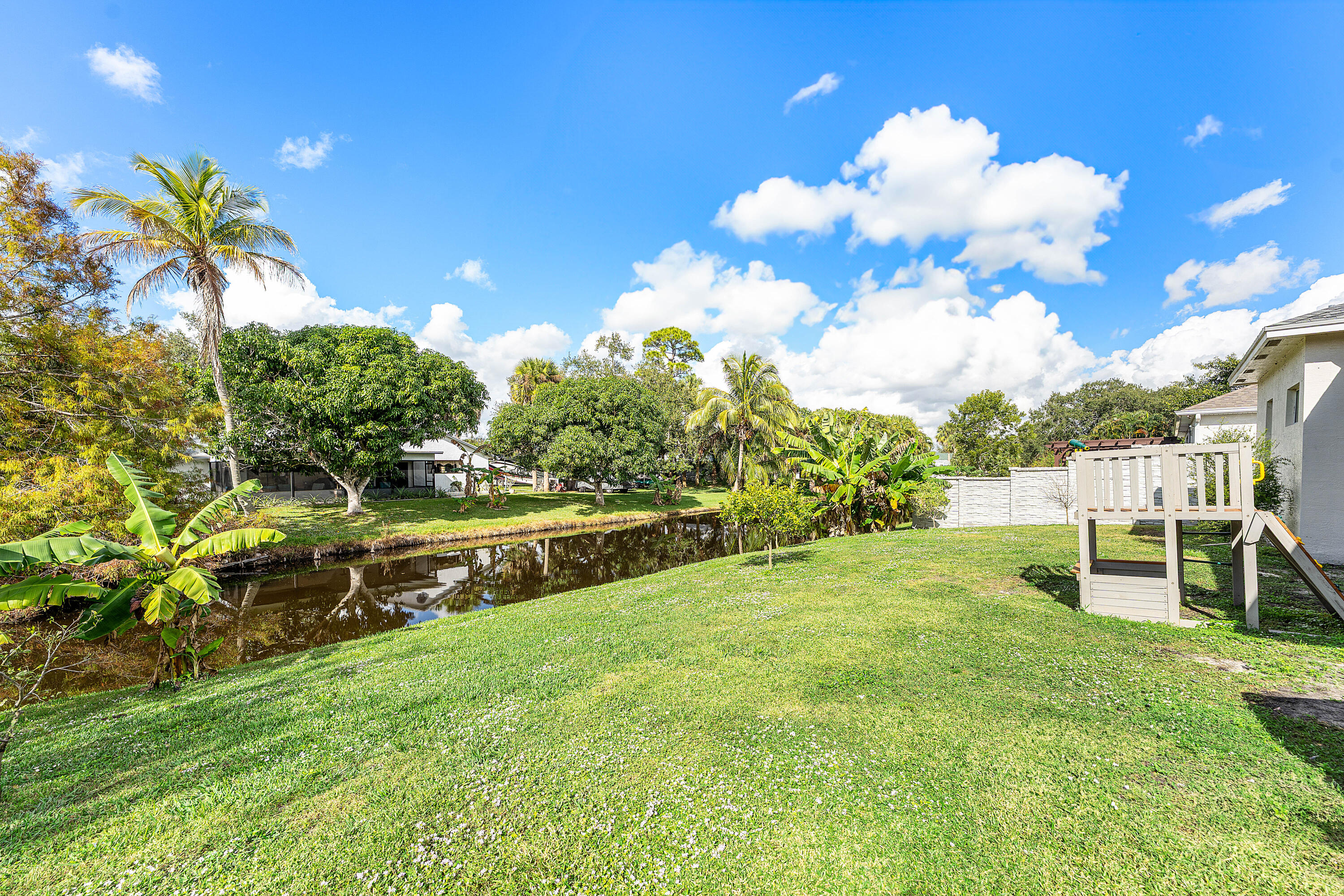 Direct water canal access for fishing and boating & no HOA hassles, just waterfront living on your own terms. This updated 5 bedroom home features PGT impact windows, granite counters, GE appliances, and high ceilings throughout. Spacious backyard with patio and cabana bath. 3-car garage with plenty of depth. Located in Port St. Lucie's convenient waterfront community with easy access to shopping, dining, schools, and recreation. No restrictions, no fees! Just a well maintained home on a great lot. Perfect for boaters and families who want waterfront living without the HOA drama.