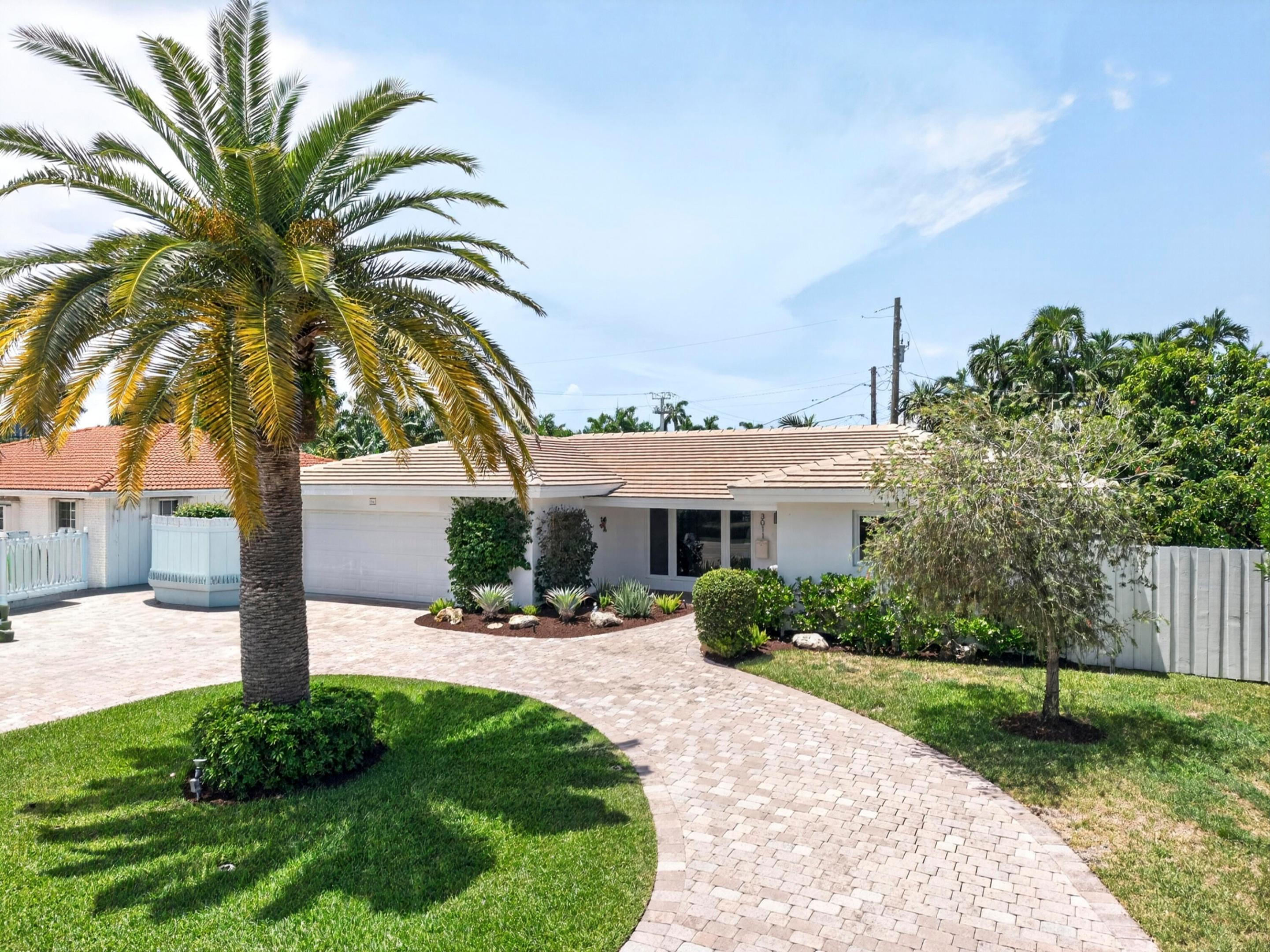 Beautifully updated home in fabulous community shows like a model & offers: Updated kitchen w/new frig ('26), center island, pass-thru to rear pool area, beautiful Travertine Marble floors thru-out, updated baths w/tile & granite (MBR has steam shower), ADT security system w/ring + 3 other cameras, speaker system thru-out, new HVAC ('25) w/powerful UV system, impact doors & windows, new W/D, oversized 2-car garage w/large extra  work alcove + custom painted floor, newer tile roof ('24). incredible in-ground heated pool & spa area w/deck pavers, fountain, & ample space for entertaining w/covered custom metal & screen lanai. Such a special home w/great curb appeal, circular paver driveway, lush landscaping w/sprinkler system & producing mango & avocado trees at such an incredible price!