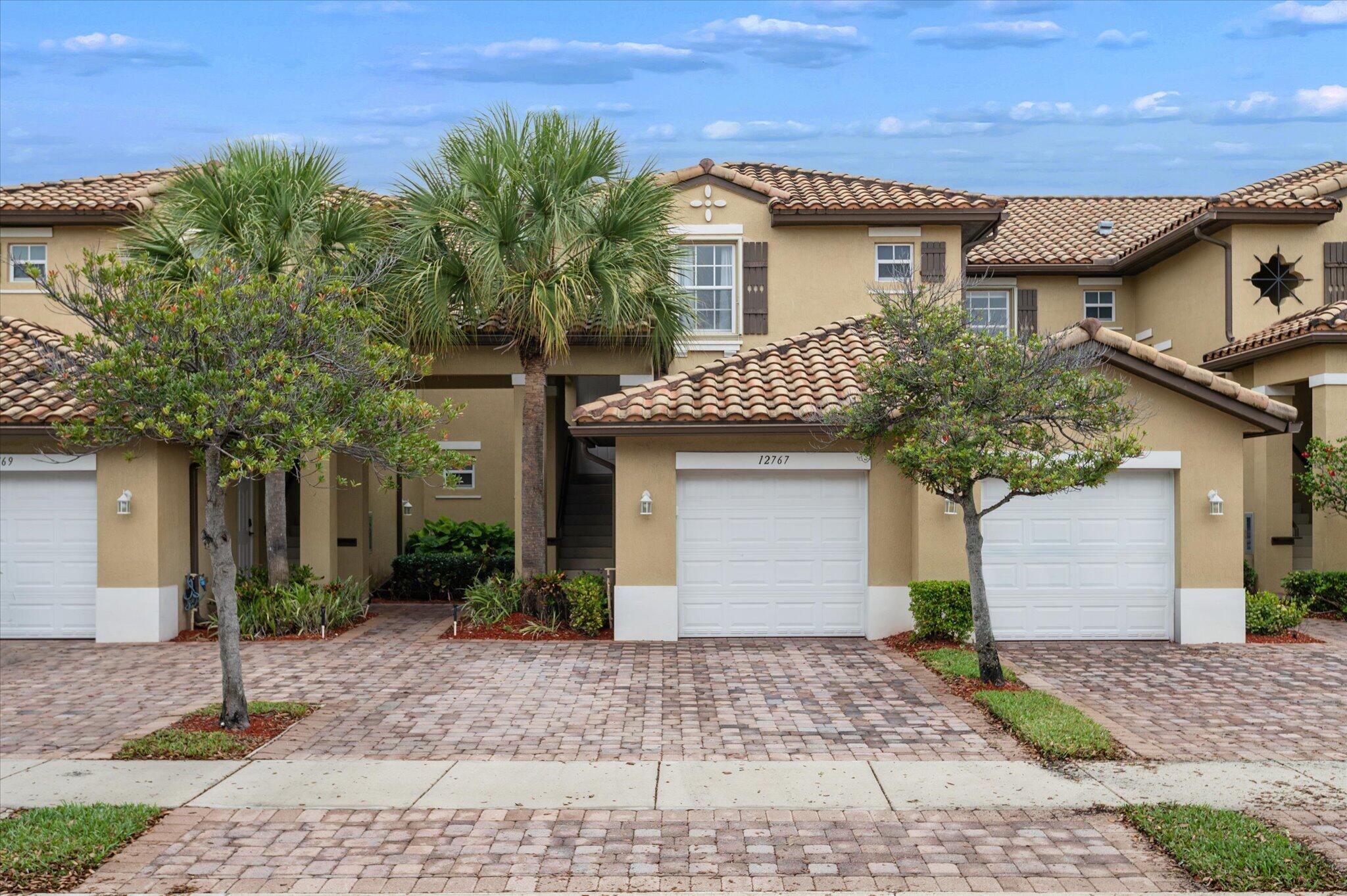 Immaculate Heron Bay coach home that shows like a model! Lightly used just a few months per year, this bright and spacious residence offers tranquil views from the moment you enter. Features include accordion hurricane shutters, custom fixtures, oversized tile in living areas, wood floors in bedrooms, and a 1-car garage. The upgraded kitchen boasts granite countertops, stainless steel appliances, wine cooler, pantry, and snack bar. The stunning primary suite offers wood floors and walk-in closets, while the spa-like bath features a floor-to-ceiling tiled glass shower and oversized vanity. Private covered patio. Association includes full amenities, clubhouse, tennis, exterior insurance, and more.