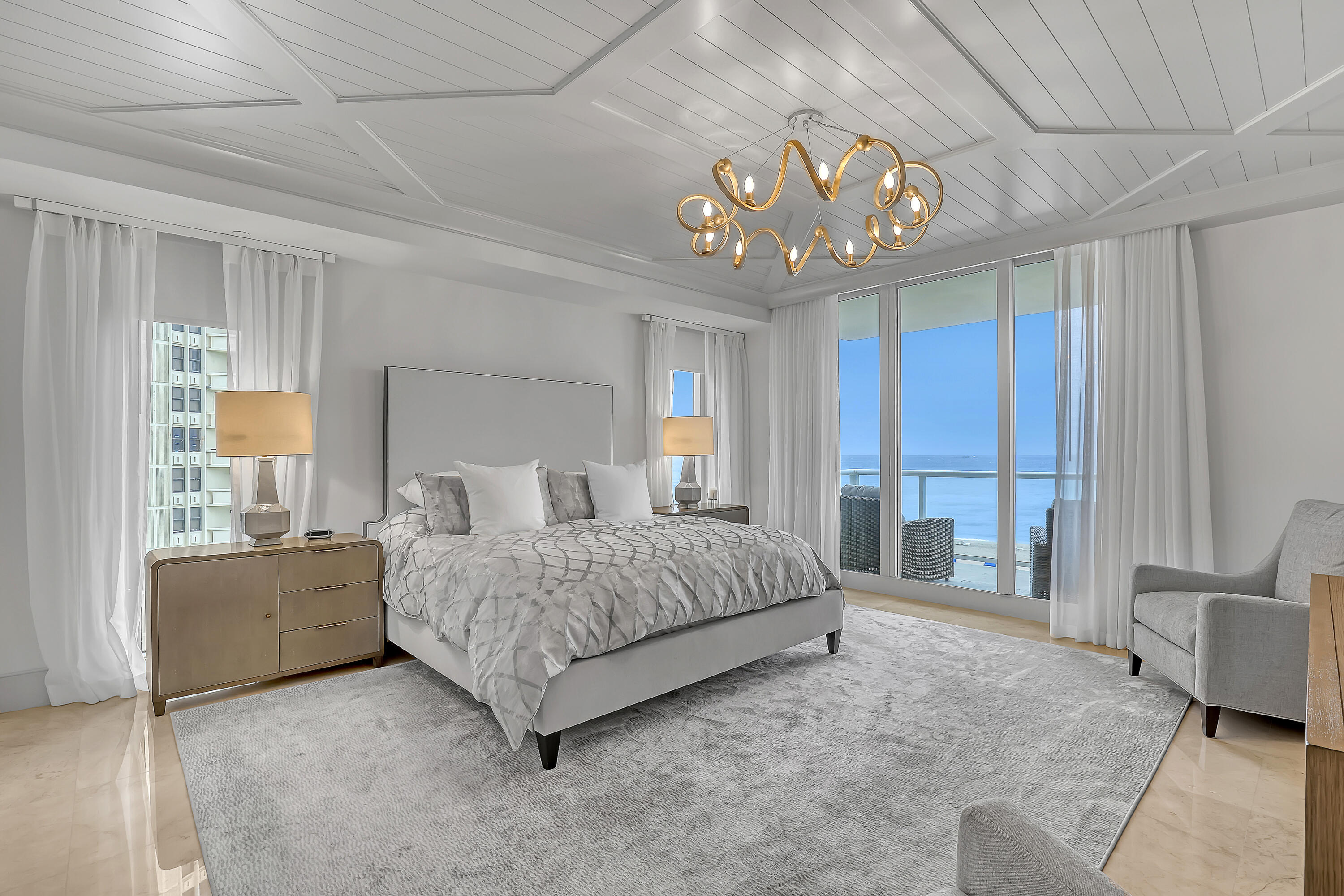 Welcome to Residence 401 in the coveted A Building at The Ritz-Carlton Residences Singer Island an exceptional offering that defines coastal luxury living.  This meticulously redesigned residence has been finished to the highest standards by a renowned Toronto-based designer, blending sophistication with modern elegance throughout. A private elevator opens directly into your expansive home, featuring 3 bedrooms plus a den and 3.5 beautifully appointed bathrooms.  Enjoy breathtaking panoramic views of both the Atlantic Ocean and Intracoastal Waterway from every room, enhanced by sleek glass balcony railings designed to maximize the scenery. The gourmet chef's kitchen is outfitted with top-of-the-line appliances,  including Wolf, Sub-Zero, Bosch, offering both style and performance.  The spacious primary suite is a private retreat, complete with dual vanities, a jetted soaking tub, and a glass-enclosed walk-in shower. Additional highlights include a large laundry room, two under-building parking spaces, and thoughtfully curated finishes throughout.  This is a rare opportunity to own one of the finest residences on Singer Island where luxury, privacy, and unparalleled views come together seamlessly.