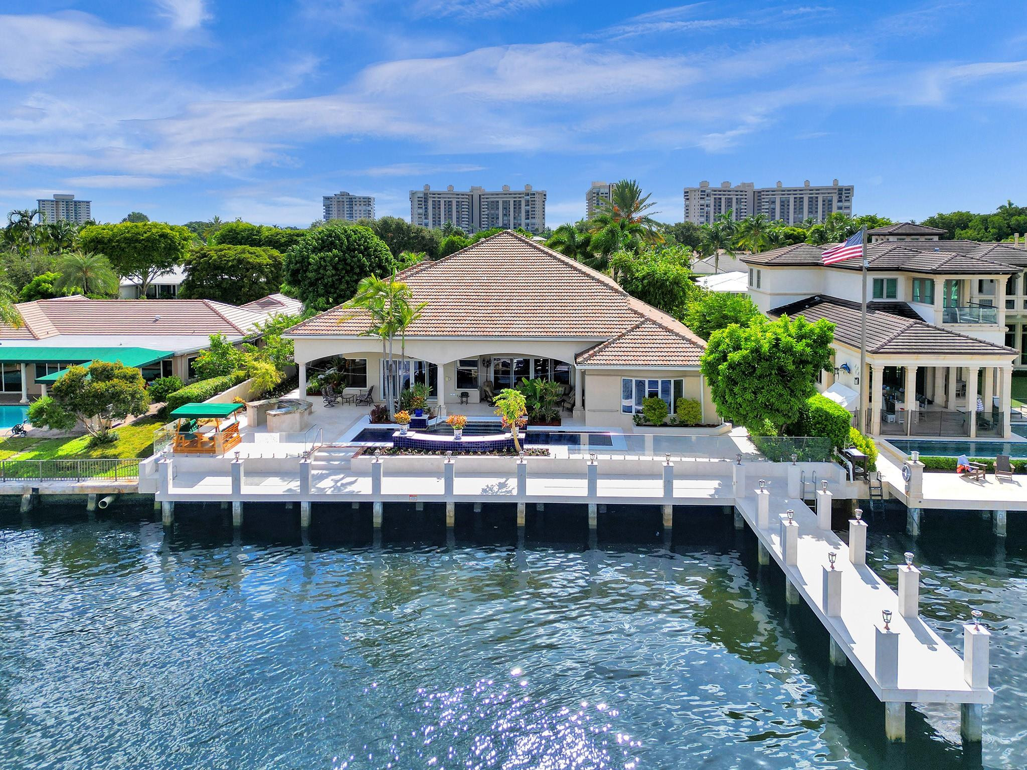 THIS REMARKABLE ESTATE FEATURES BEAUTIFUL WATER VIEWS AND SPANS AN APPROXIMATE 100 FT OF WATER FRONTAGE ON THE INTRACOASTAL WATERWAY. ENTERTAINING IS ENJOYED AROUND THE RESORT STYLE POOL ALONG WITH THE 100 FOOT CONCRETE DOCK WITH OUTDOOR LIGHTING COUPLED WITH NEW GLASS RAILING SYSTEM AND NEW OUTDOOR FLOORING. A FORMAL FOYER ENTRANCE LEADS YOU TO THE SOARING 20FT CEILING IN THE MAIN DINING AREA AND 16 FT CEILING IN THE LIVING ROOM & KITCHEN AREA. CREATED WITH REMARKABLE CRAFTSMANSHIP AND CUSTOM CABINETRY THROUGHOUT, THE FIRST LEVEL PRIMARY SUITE FEATURES HIS & HERS LARGE WALK IN CLOSETS LEADING TO A VERY LARGE SPA LIKE BATH & JACUZZI TUB. A WRAPAROUND STAIRCASE LEADS YOU TO THE SECOND LEVEL WHICH OFFERS 2 BEDROOMS AND AN ENCLOSED WORKOUT ROOM. ENJOY MAGNIFICENT WATER VIEWS THROUGHOUT.