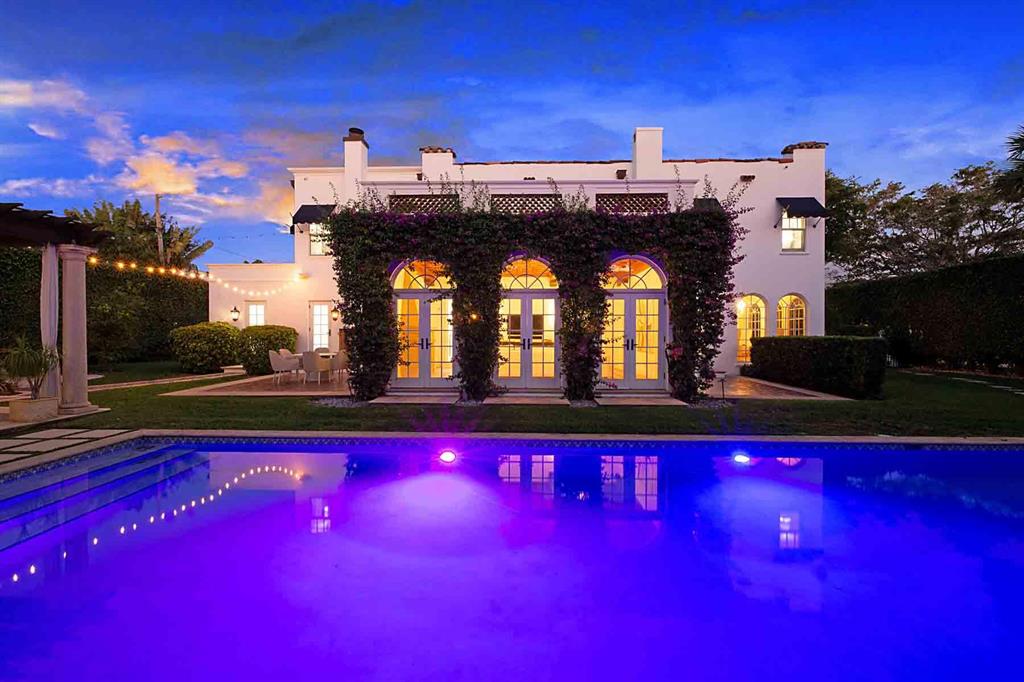 Welcome to this newly renovated glamorous Southern California interior meets Mediterranean mission Old Northwood home. A 1925 Architectural Masterpiece built by J.A. Bowery. Mission Style 2 - Story Home.
Renovated by a distinguished interior designer. Fresh, soothing white-blonde tones are throughout the 4-bedroom all ensuite - 5.5 bathroom house. Stunning additions include a Christopher Peacock epicurean kitchen, luxurious Waterworks bath fixtures, white brushed walls, custom wood impact windows and doors, and Paris Ceramics antique tile in the family room and bar area. 
The spacious family room includes a gas-stone fireplace and hand-wood-crafted inlaid ceiling. The family room, with a bank of French doors, as well as all doors, leads to a dramatic backyard of contemporary, manicured gardens and a romantic entertaining area.
The dreamy 40 by 15-foot pool area includes a grilling area, outdoor fireplace, dining area, and fountain where you can enjoy your charcuterie and chardonnay.
Note the convenient first-floor office and utility room! A 2 story air-conditioned guest cottage with outdoor loggia and Juliet balcony dresses up the backyard as well as an air-conditioned 2-car garage on the property as well. 
The well-appointed finishes take you on an amazing journey of a must-see one of a kind rare find. You'll be the star of the neighborhood in this modern jewel.