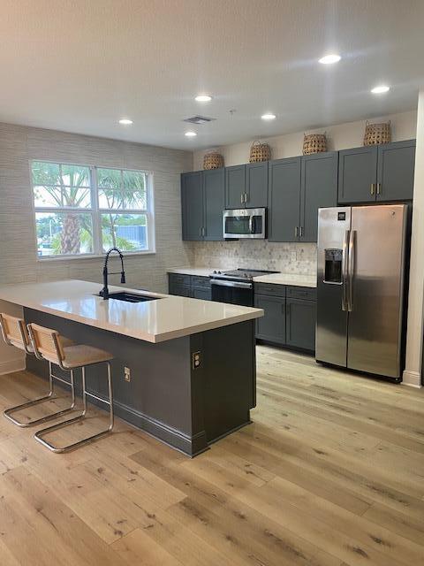 Beautifully updated home with a desirable southern exposure that fills the interior with natural light. The open-concept kitchen flows seamlessly into the living and dining area and features brand-new countertops, a coordinating backsplash, new stove, and new dishwasher. Stunning upgrades include beautifully remodeled bathrooms, brand-new flooring, a sleek custom staircase, designer wallpaper, new lighting fixtures, a brand-new A/C system, and impact windows and doors for comfort and peace of mind. Enjoy two balconies, a private covered patio, an attached garage with an electric vehicle charging hookup, and plenty of guest parking. Residents can enjoy a community pool and basketball court. Move-in ready with modern finishes and timeless style.