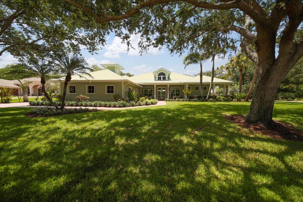 Move-in confidence begins w/quality construction & exceptional updates. This concrete block residence in Palm City gated Windstone comm. offers 3BR+office, 3BA, 3,133± living SF, an oversized 2CG, & desirable split floor plan. The family room & updated kitchen serve as the heart of the home w/ quartz countertops, premium KitchenAid appl., glass tile backsplash, & bay-window breakfast nook overlooking the recently resurfaced pool & expansive covered patio offering built in summer kitchen. Entertain w/ease w/open living & dining room concept. Oak hardwood floors, updated lighting & crown molding add timeless appeal throughout. Complete w/metal roof, 2 new A/C systems (2026), 2022 water heater & impact windows for peace of mind. Low HOA locatied close to A-rated schools, golf, shopping,  dining, downtown Stuart, & beautiful Treasure Coast beaches.